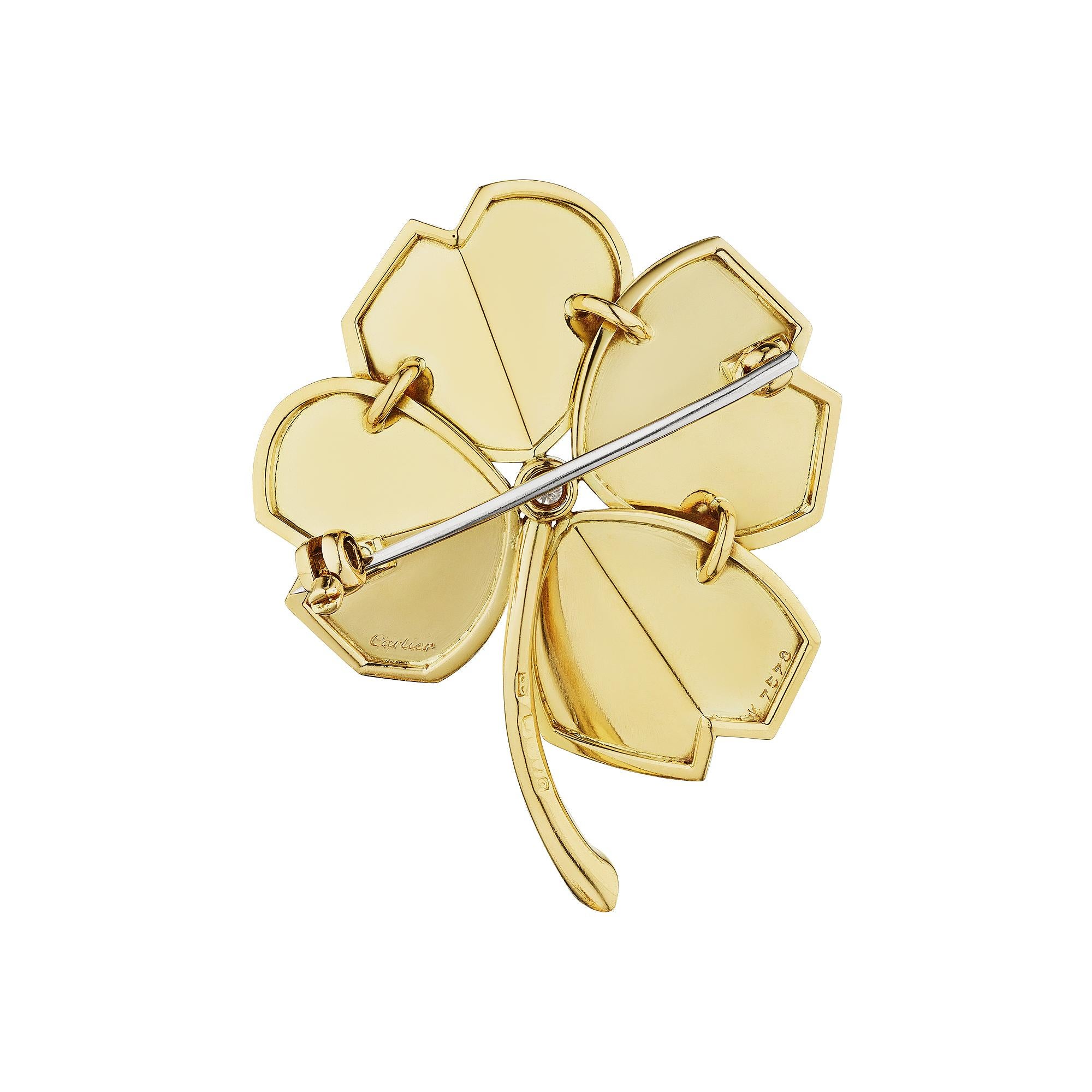 Rare to find but lucky to have, this mid-century Cartier diamond gold brooch is charmed.  With a round center diamond and linear engraved two dimensional leaves, this four leaf clover will keep you golden.  Circa 1950-60.  Signed Cartier.  Center