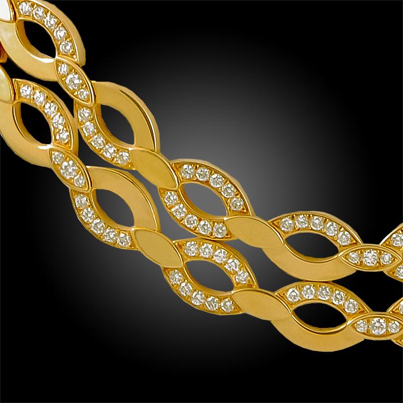 A simple, elegant Cartier diamond necklace in 18k gold; designed two rows of elliptical hoops intermittently set with brilliant-cut diamonds weighing approximately 4.6 carats. Measures 17 inches long.

Signed Cartier and numbered.