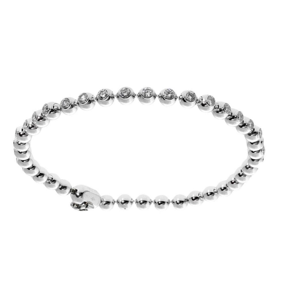 A chic authentic Cartier beaded tennis bracelet in 18k white gold featuring 2.04cts of the finest Vs quality round brilliant cut diamonds. 

Length: 6 1/2″ 

