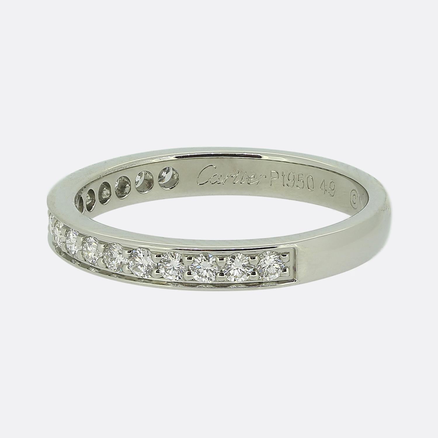 Here we have a classically styled diamond half-eternity ring from the world renowned luxury jewellery house of Cartier. This platinum piece features 17 round brilliant cut diamonds in a single line formation; all which have been individually claw