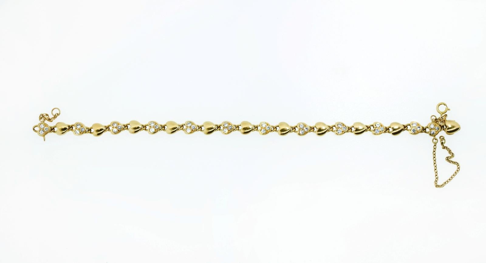 Cartier 18KT yellow gold alternating diamond heart links bracelet.  Set with thirty six Round Brilliant Cut Diamonds weighing approx. 1.08 carats of G-H color - VS clarity.  The 7 inch long bracelet is completed with an invisible clasp and two