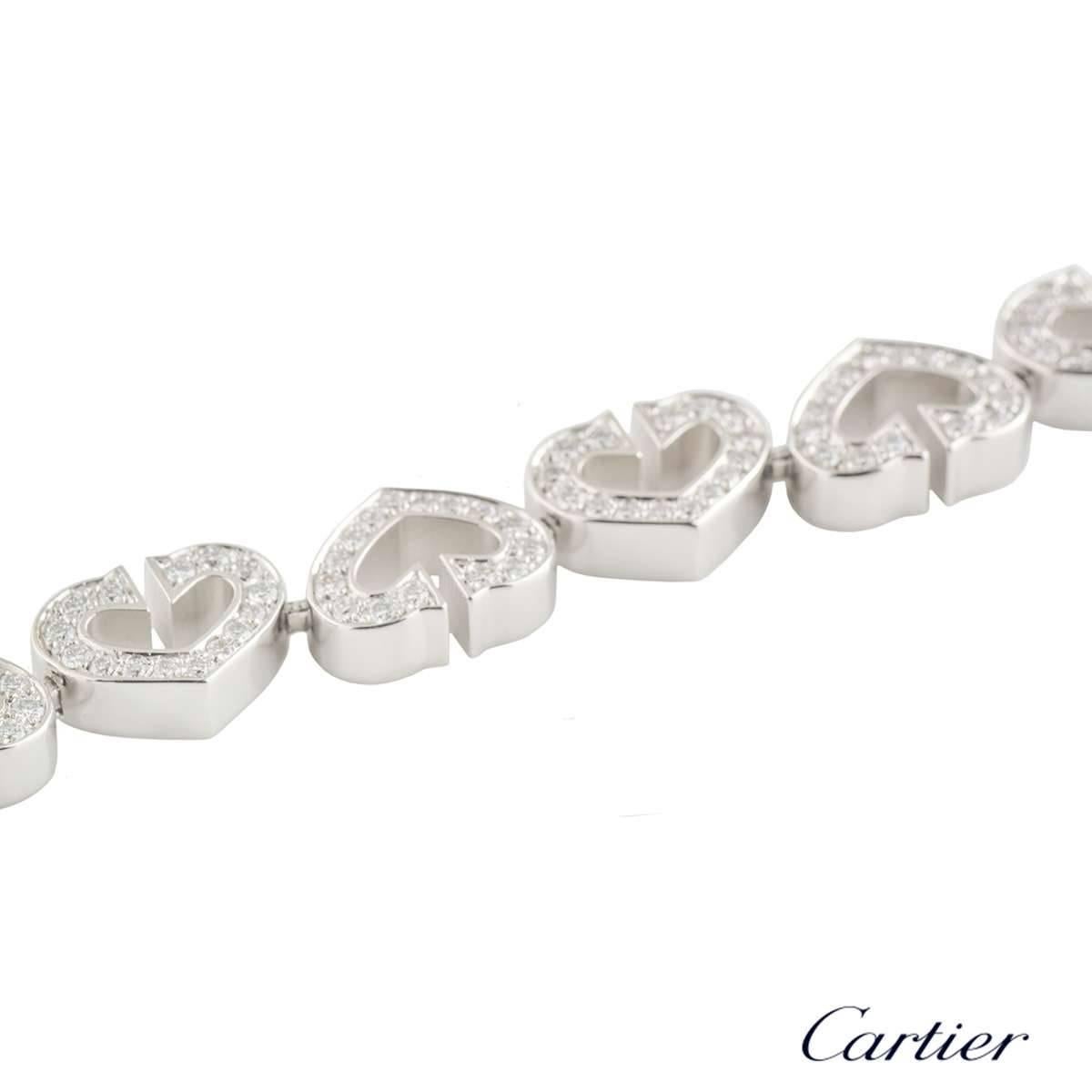 A beautiful 18k white gold diamond Cartier bracelet from the Hearts and Symbols collection. The bracelet comprises of 18 heart motifs perfectly fitting together like a jigsaw, with 15 round brilliant cut diamonds in a pave setting. There are 270