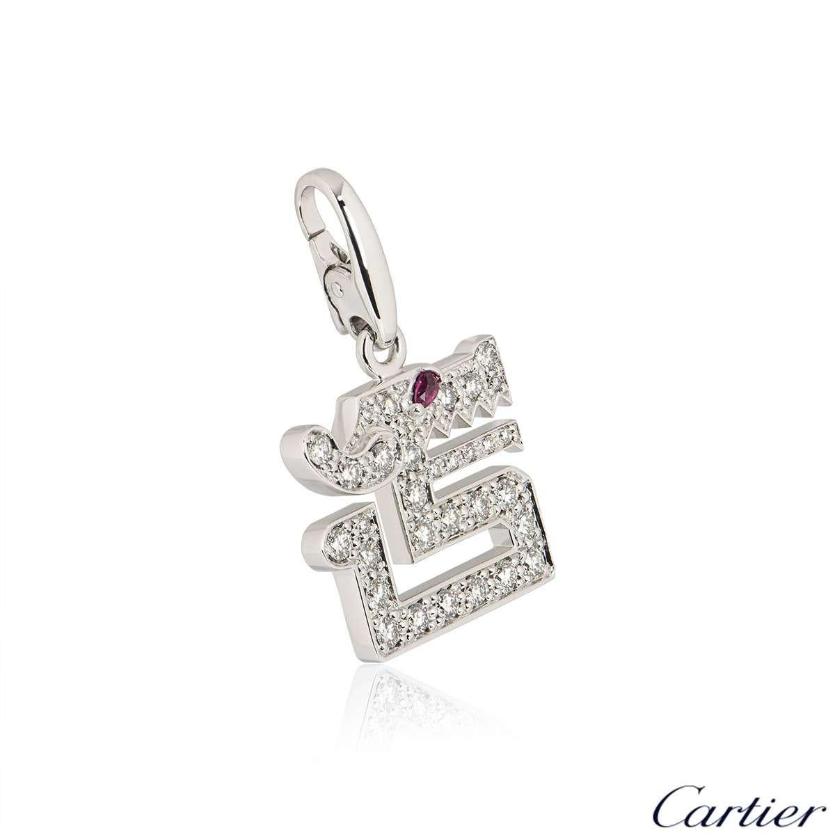 An 18k white gold Le Basier Du Dragon charm by Cartier. The charm is set with round brilliant cut diamonds totalling approximately 0.46ct and a single pear cut ruby for the eye weighing approximately 0.02ct. The charm measures 1.5cm in width and