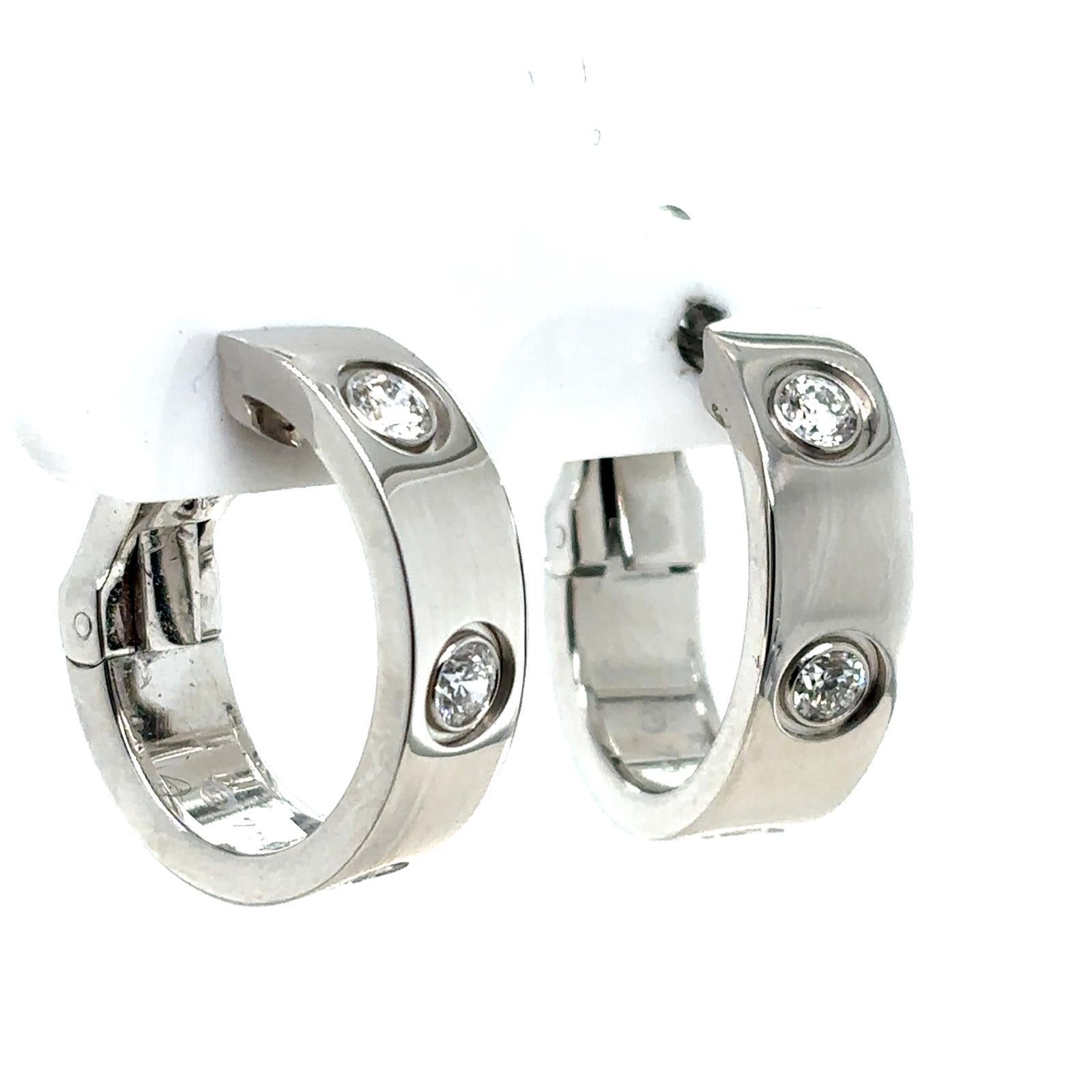 Un par de pendientes Love de diamantes Cartier de oro blanco de 18 quilates.

Este clásico par de pendientes de aro Love de diamantes Cartier vintage están engastados en oro blanco de 18 quilates con el emblemático diseño Love de Cartier.

Cada
