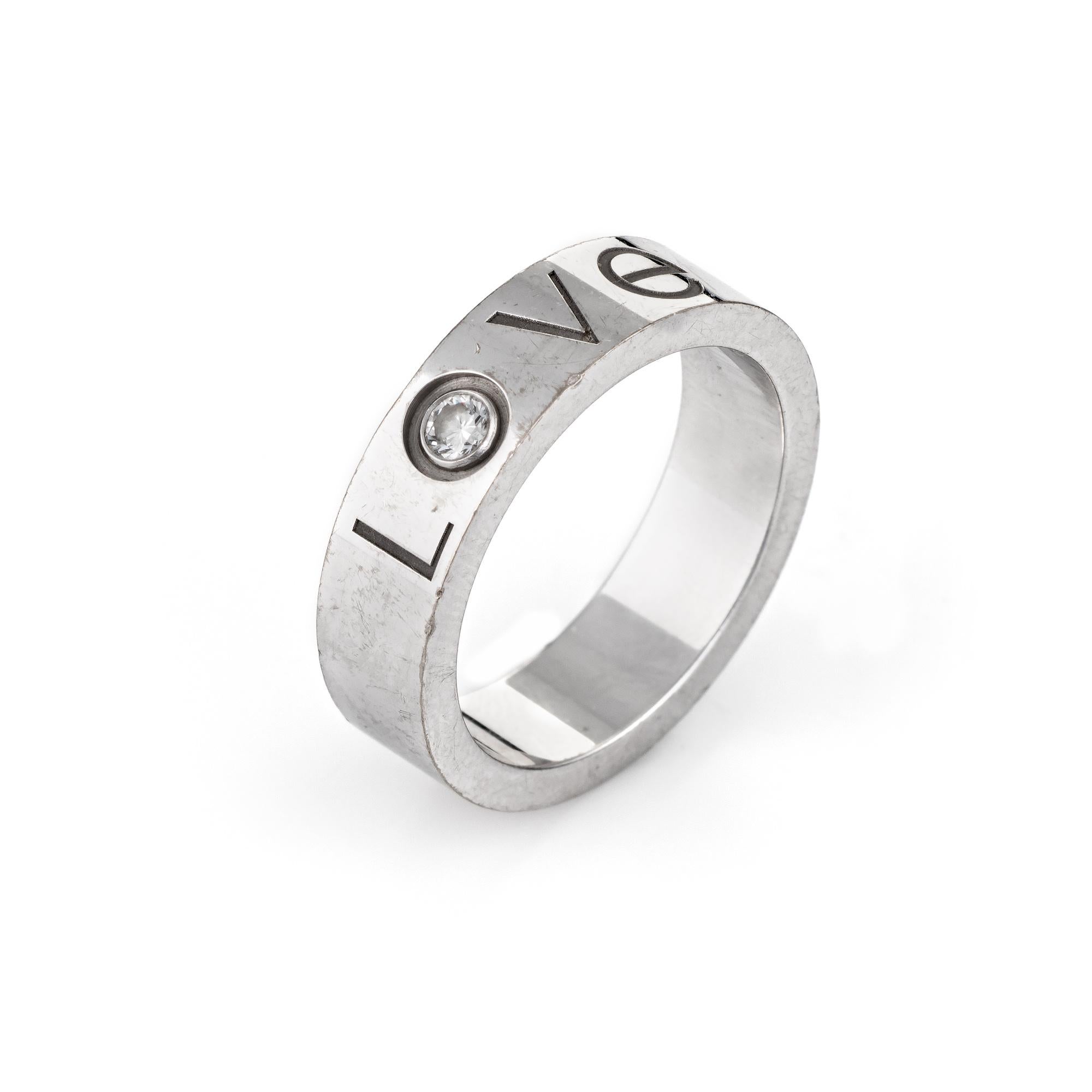 Pre owned Cartier diamond LOVE logo ring, crafted in 18 karat white gold.  

The ring is set with an estimated 0.05 carat diamond (estimated at F-G color and VVS2 clarity). 

The ring is in very good condition. It is no longer available for sale at