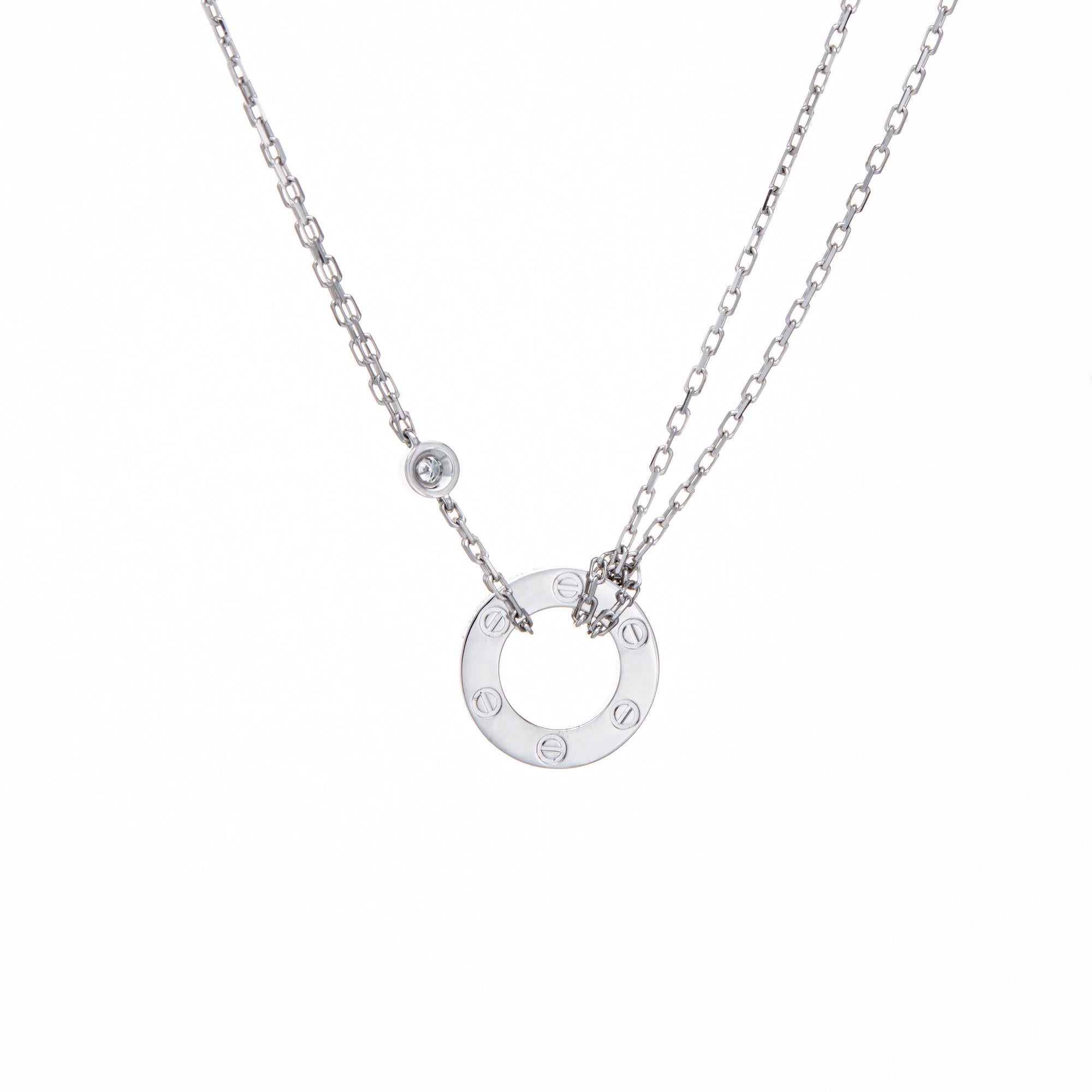Pre-owned Cartier Diamond Love necklace crafted in 18k white gold.  

2 diamonds total 0.03 carats (estimated at G-H color and VVS2 clarity). The classic Cartier necklace features a double chain with a diamond set LOVE inscribed center. The necklace