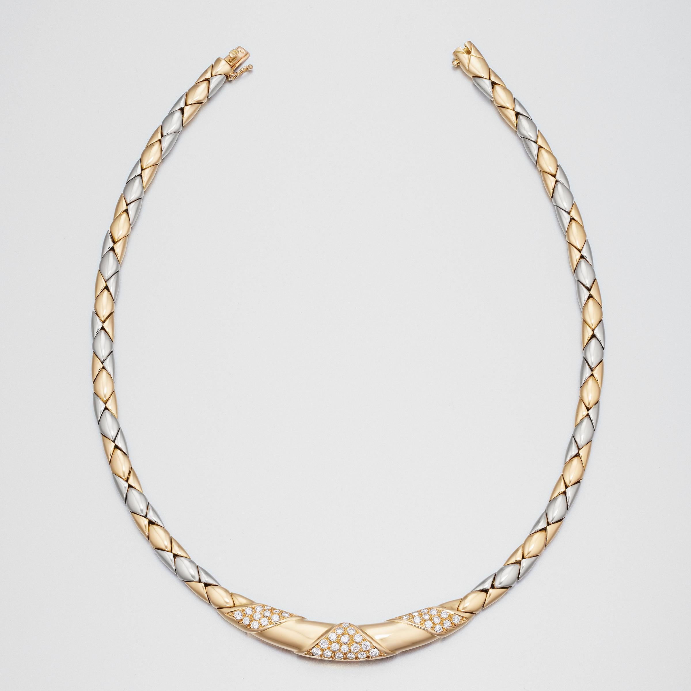 Exceptional Cartier diamond necklace in 18 karat yellow and white gold. The necklace is composed of alternating high-polish yellow and white gold diamond-patterned links. The wider central section of the necklace features three diamond encrusted