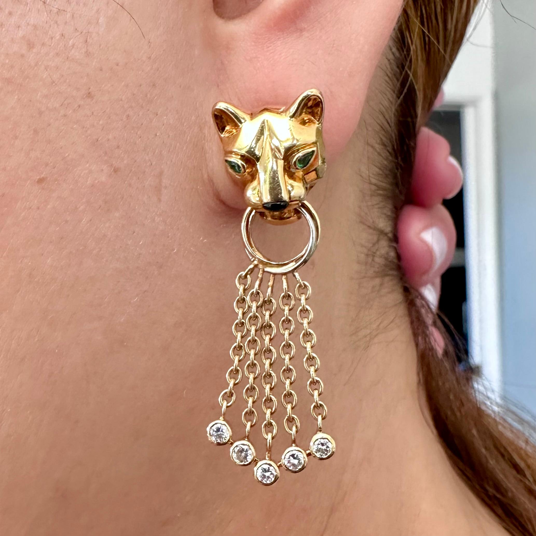 Cartier Diamond Panther Collection Earrings
Panthere's Heads Holding 18k Circles Supporting 5 Chains in a Chevron Design with Bezel set Round Brilliant Cut Diamond 
Combined Diamond, Emerald, Onyx and Yellow Gold crafted into ‘Panthère’ Earrings,