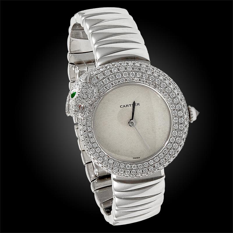 A very unique and rare Cartier women’s wristwatch featuring the iconic Cartier Panther, gracefully coiling around the bezel, pavé set with an opulence of radiant diamonds, accentuated with pear-shaped emerald eyes. Quartz movement, 28mm.
signed