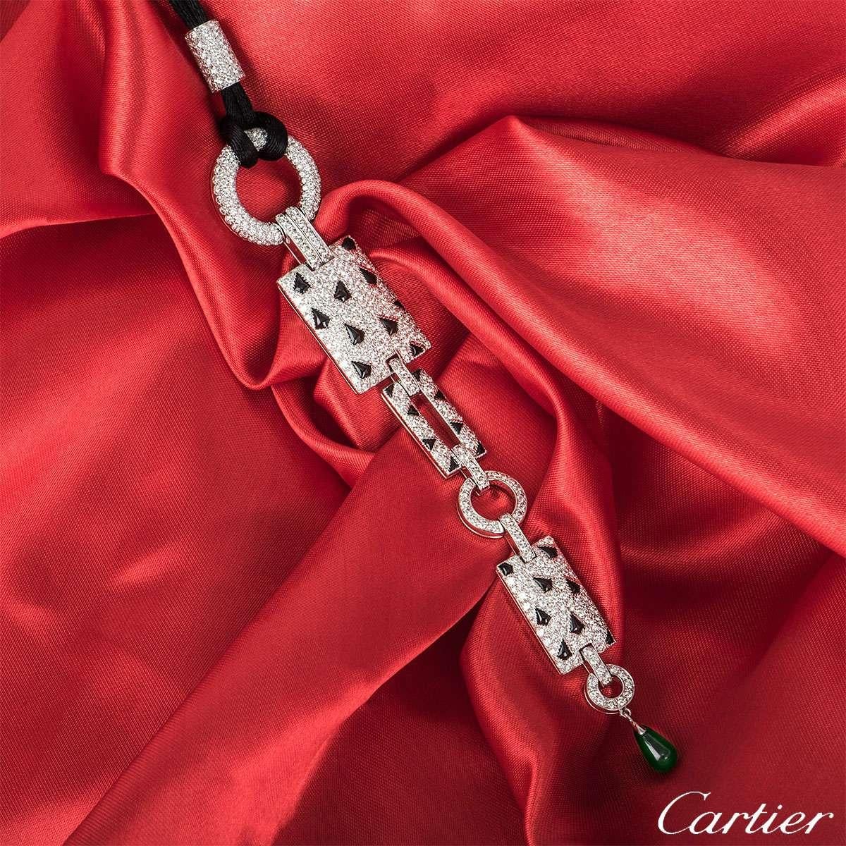 A remarkable 18k white gold Cartier necklace from the Panthere collection. The necklace is formed of circular and rectangular motifs featuring 26 scattered black onyx markings and pave set diamonds. The necklace has a total of 416 round brilliant