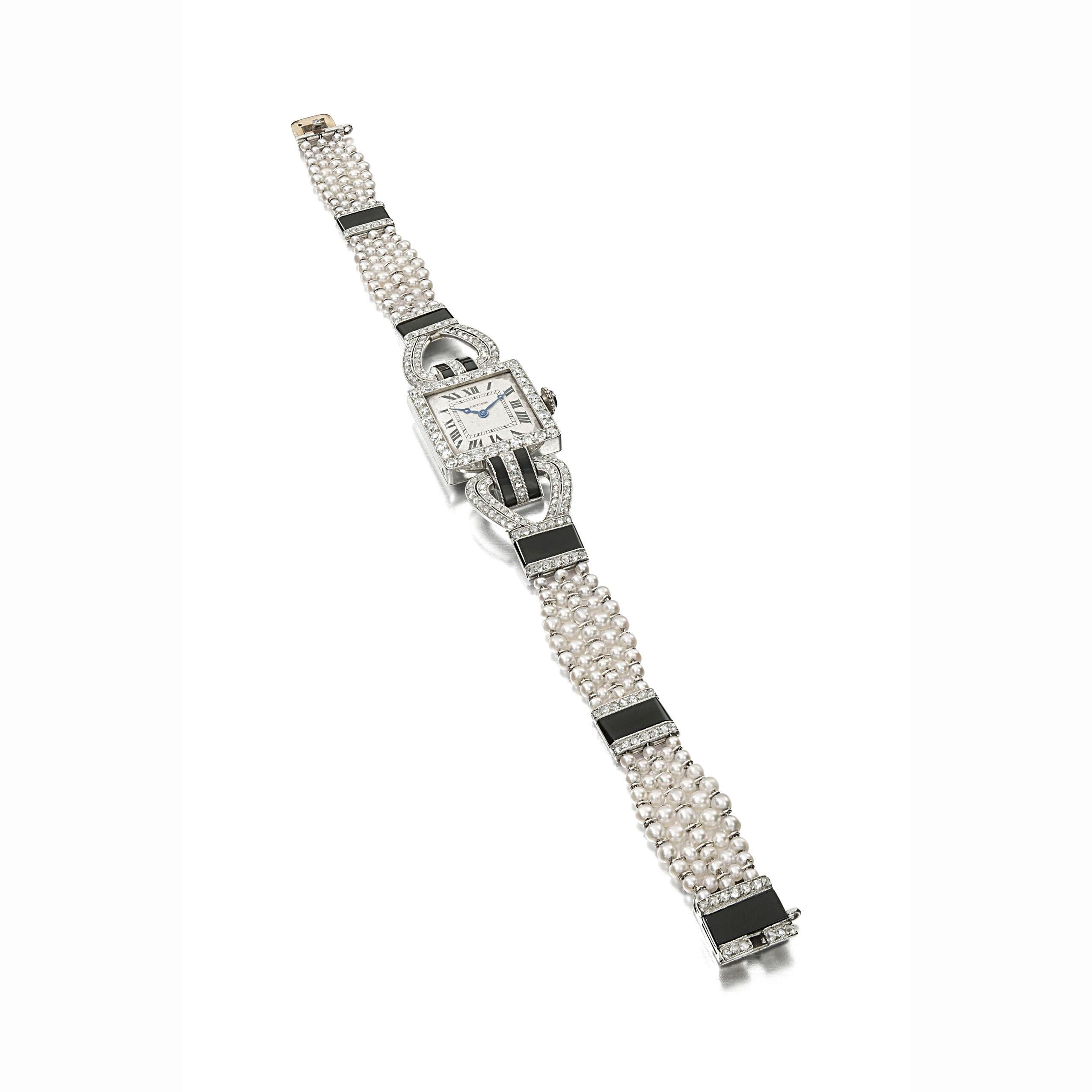 Art Deco Diamond, Pearl, and Onyx Watch by Cartier, Paris, circa 1920 

A watch with a square, cream-colored dial with Roman numerals and blued steel hands within a diamond border, a rose-cut diamond winder, onyx and diamond arched shoulders, and
