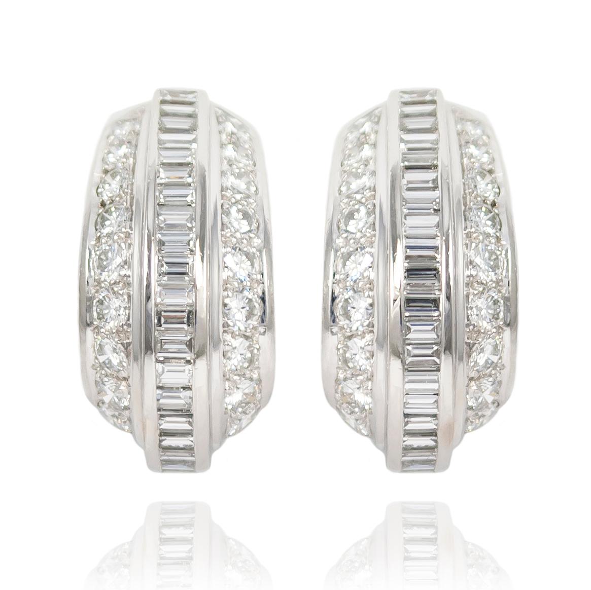 These signed Cartier earrings are the essence of sophistication... flattering on any face shape, the platinum, clip-on earrings feature straight baguettes juxtaposed with beautiful, brilliant round cut diamonds. 

