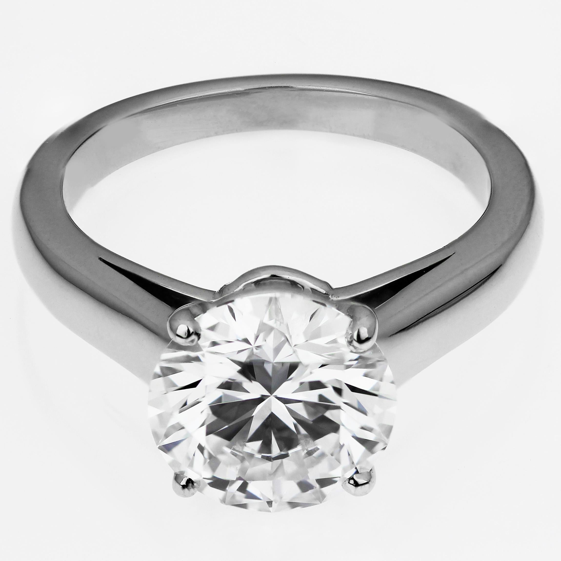 A diamond single stone solitaire ring set in platinum by Cartier with original box, receipts and Certificate. Featuring an impressive four-claw set round brilliant cut diamond, weight 2.43 ct with GIA Report no. 5131336188, laser inscribed girdle, F
