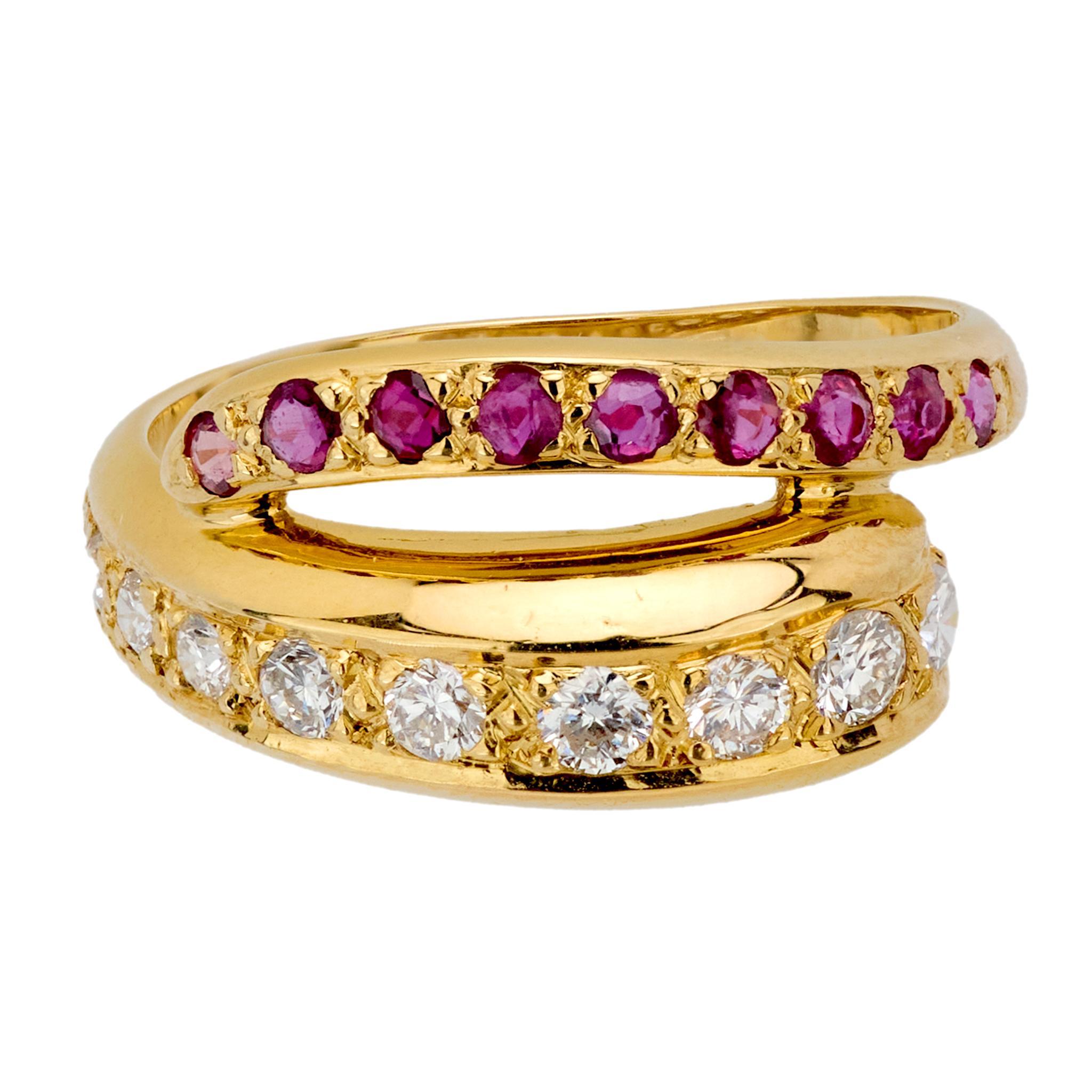 This vintage Cartier 18k yellow gold bypass band sparkles with 10 round brilliant cut diamonds totaling approximately 0.35 carats, D-E color, VS clarity, elegantly paired with 9 round cut rubies totaling approximately 0.35 carats. A striking