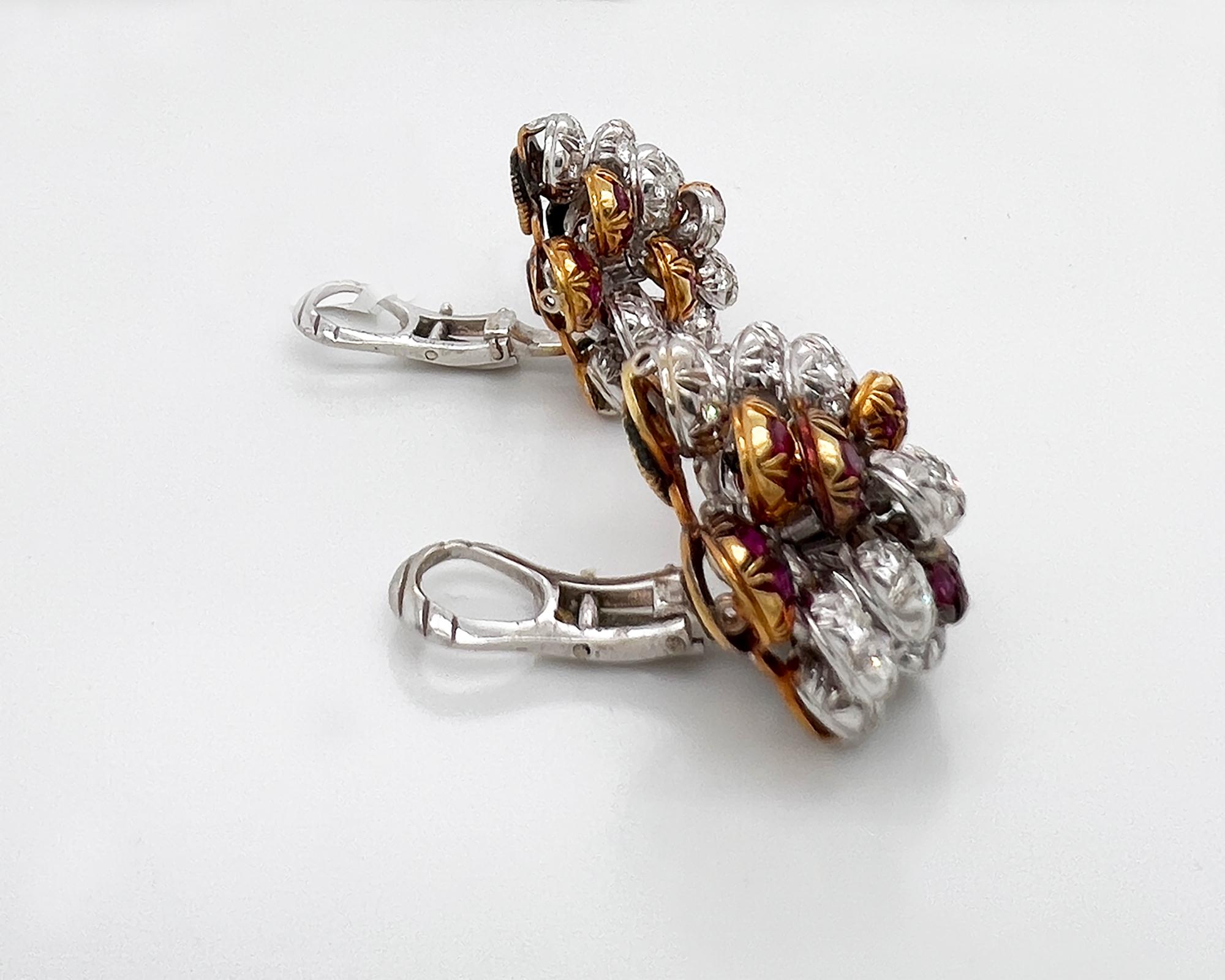 Beautiful ear clips made by Cartier in 1980s. 
Designed as clusters of balls set with diamonds and rubies arranged in multi layers. 
Metal is 18k white & yellow gold, 26.78 grams.
Signed Cartier Italy.
Clip-on style.