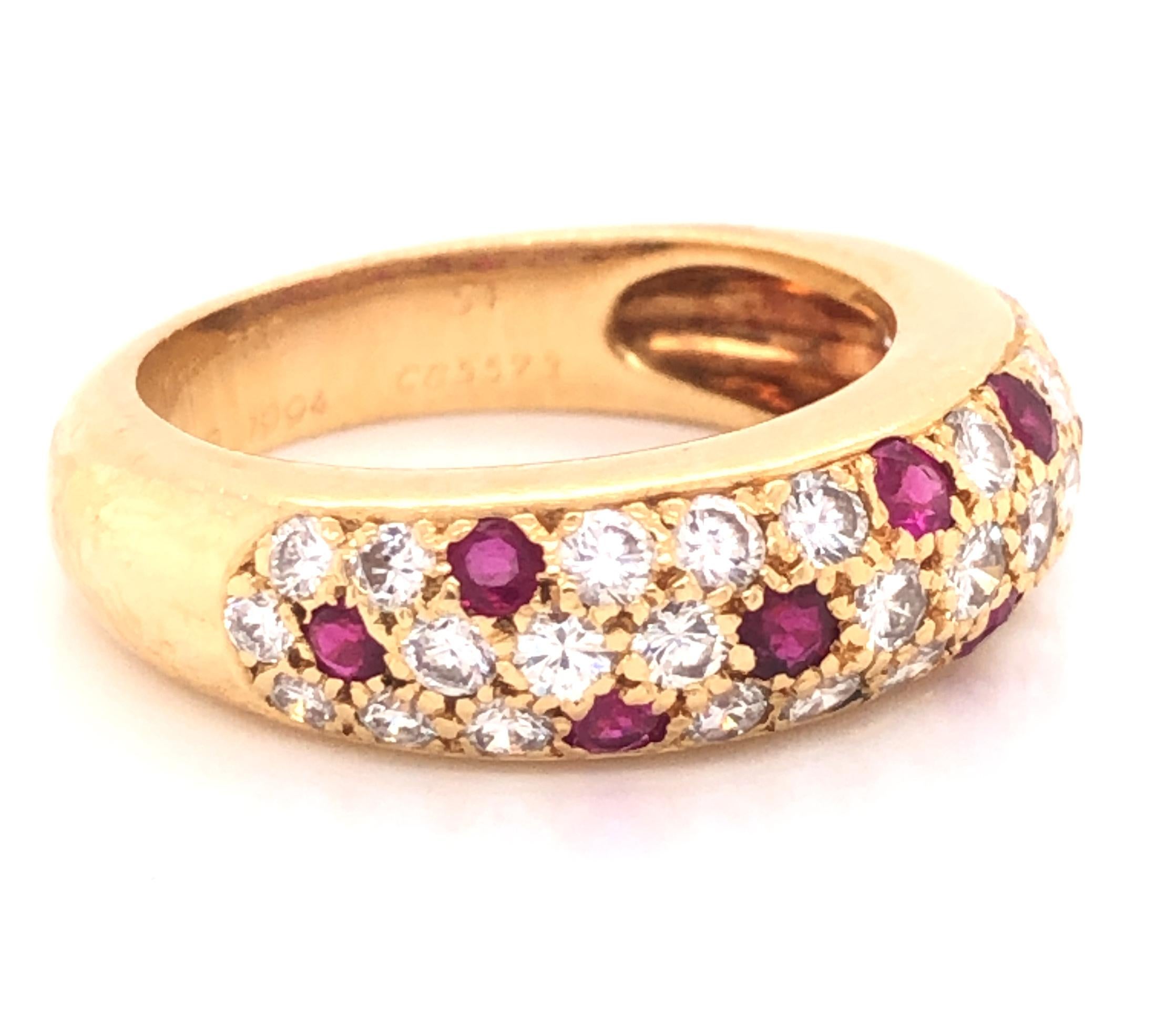 Beautiful design from famed jewelry house Cartier. This ring is crafted in 18k yellow gold, from the Mimi collection. Ring features approximately 1.00 tcw. of G/VS diamonds and rubies. The diamond and rubies set against the yellow gold truly pop off