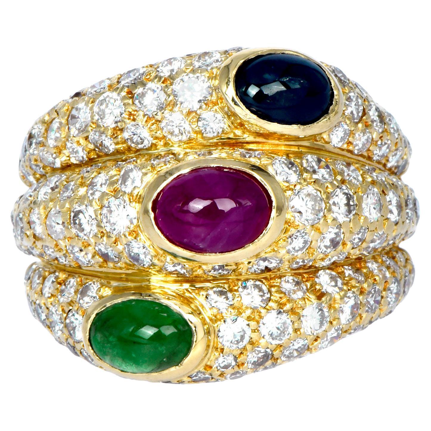 Cartier intricate and defiant design from the 1990s, Crafted in solid 18K yellow gold, with an all-time favorite tri-colors design, by 3 Cabochon oval cut, bezel-set, Genuine Emerald, Ruby & Blue Sapphire, weighing 2.20 carats in total.

Embellished