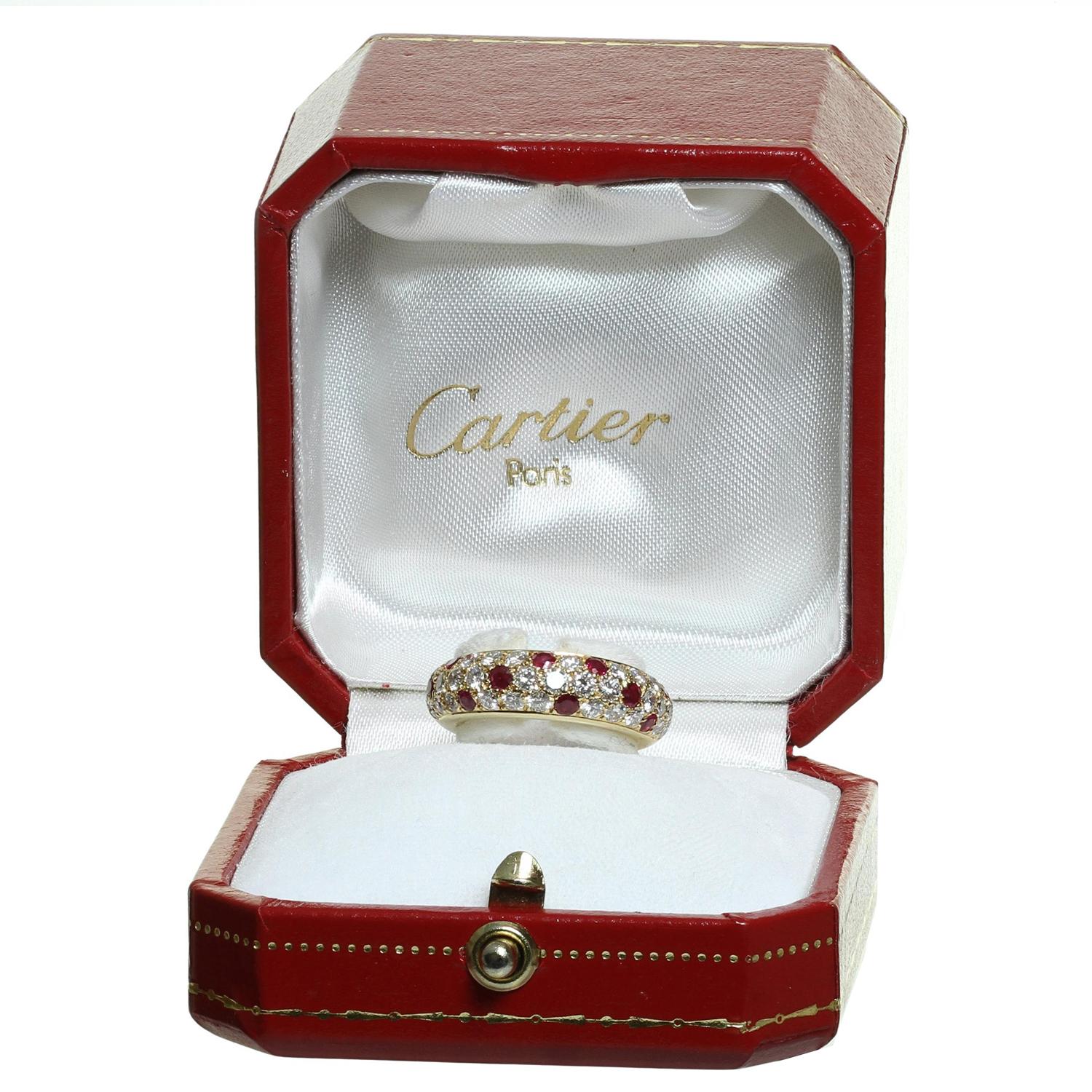 This classic Cartier ring is crafted in 18k yellow gold and pave-set with brilliant-cut round D-F VVS1-VVS2 diamonds weighing an estimated 1.36 carats and round red rubies weighing an estimated 0.60 carats. Made in France circa 1994. Measurements: