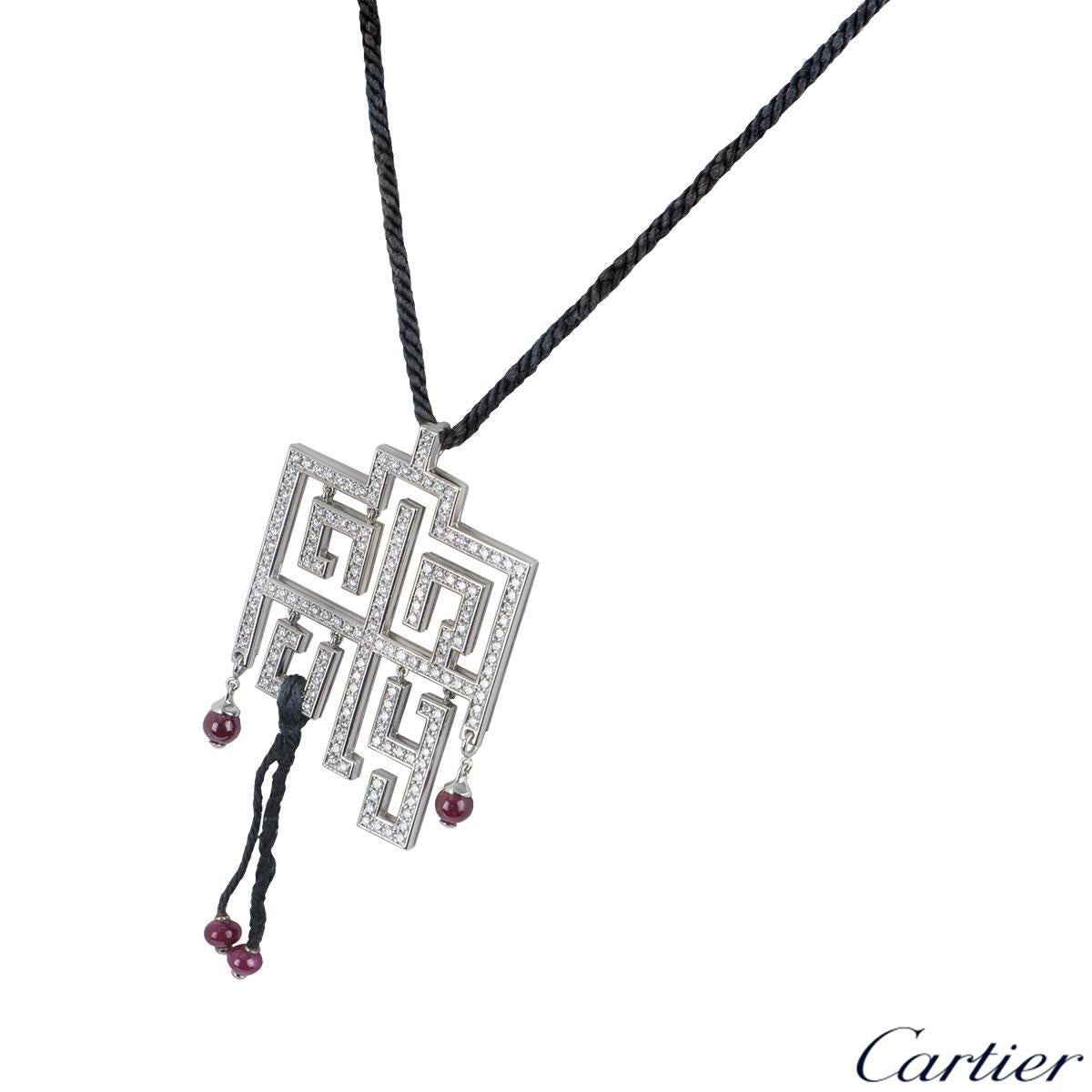 A stylish 18k white gold pendant by Cartier from the Le Baiser Du Dragon collection. The pendant features a pave diamond set openwork oriental plaque, set with 169 round brilliant cut diamonds totalling approximately 2.41ct. The plaque suspends 4