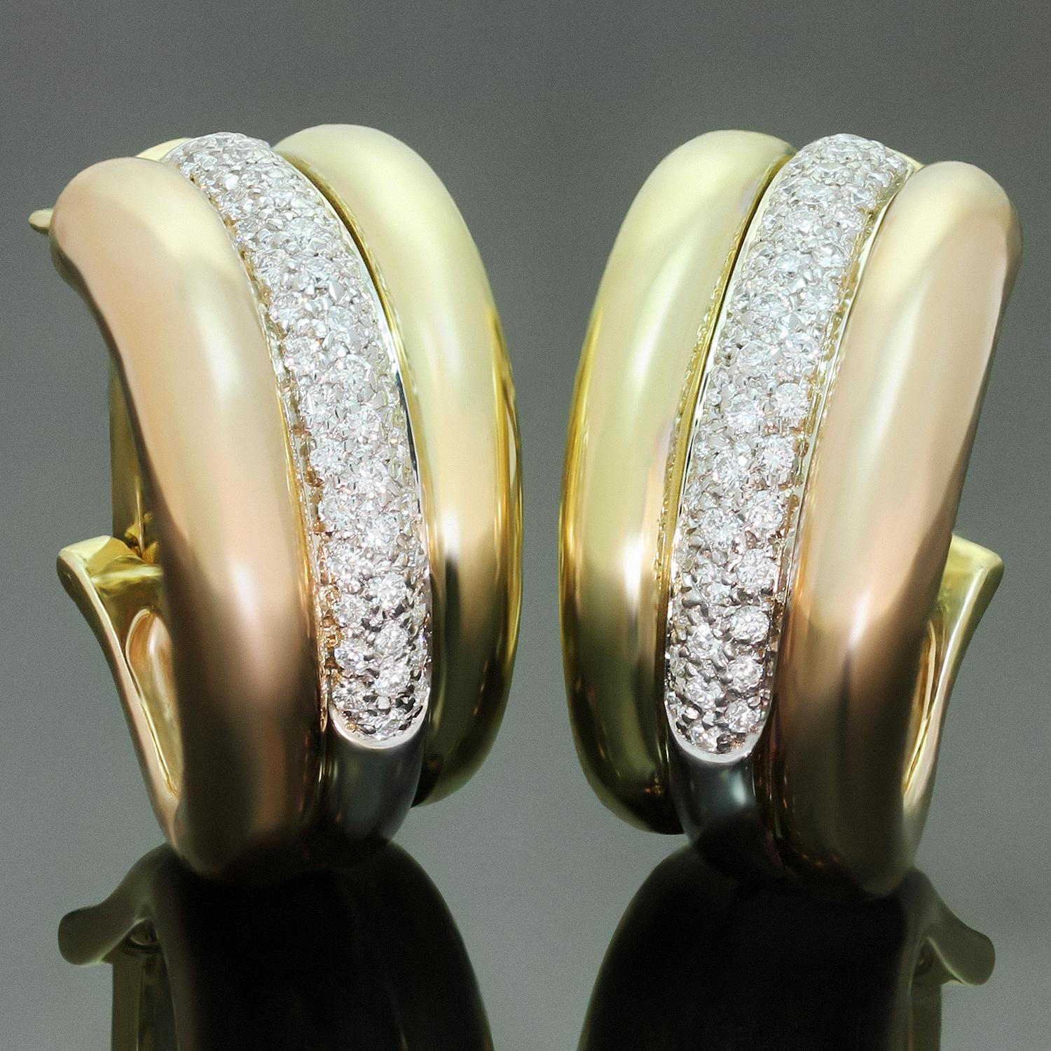 These gorgeous oval wrap earrings from Cartier's Trinity collection are crafted in 18k yellow, white and rose gold and pave-set with F-G VVS1-VVS2 brilliant-cut round diamonds of an estimated 1.35 carats in white gold. An iconic design for everyday