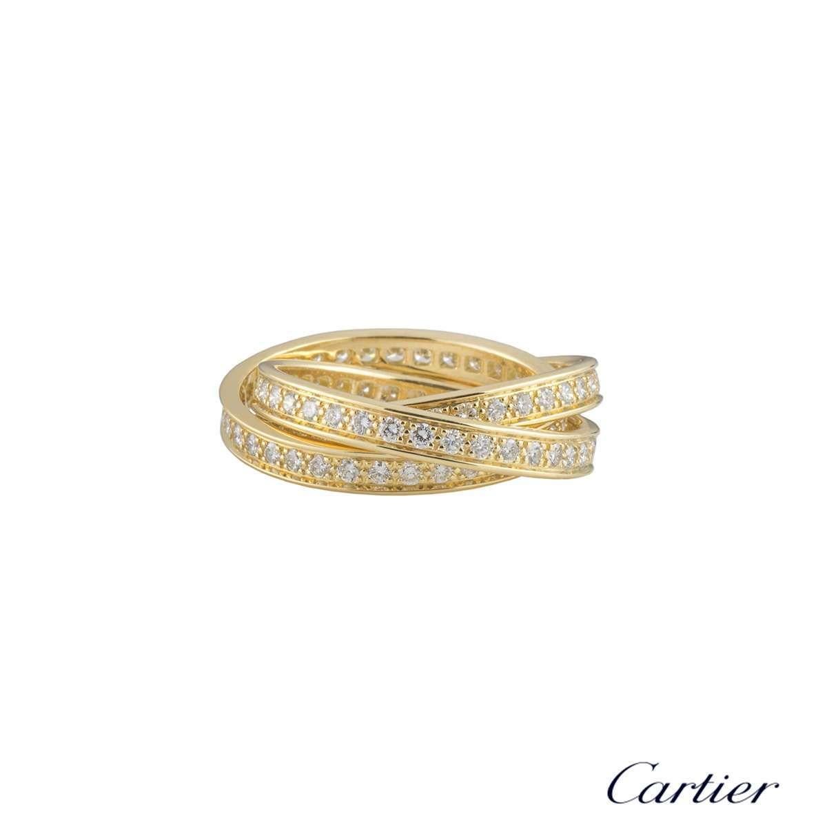 An iconic 18k yellow gold diamond set Cartier ring from the Trinity de Cartier collection. The ring is composed of three entwined round brilliant cut diamond set bands each 3mm in width, totalling approximately 1.55ct, G+ colour and VS+ clarity. The