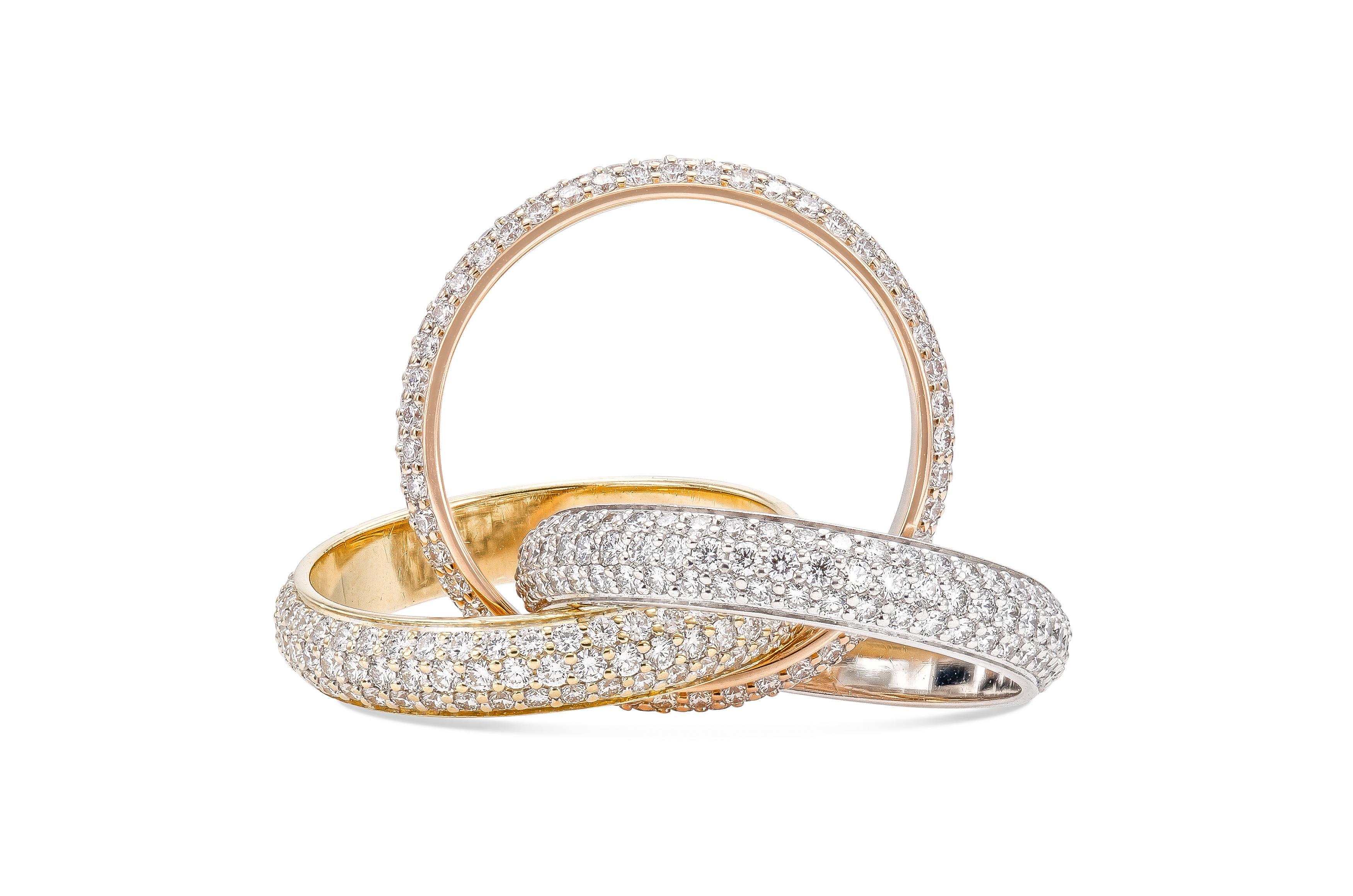 Finely crafted in 18k rose, yellow, and white gold with pave-set Round Brilliant cut Diamonds weighing a total of approximately 3.00 carats.
Signed by Cartier, from their Trinity collection.
Size 50 (US 5 1/4)