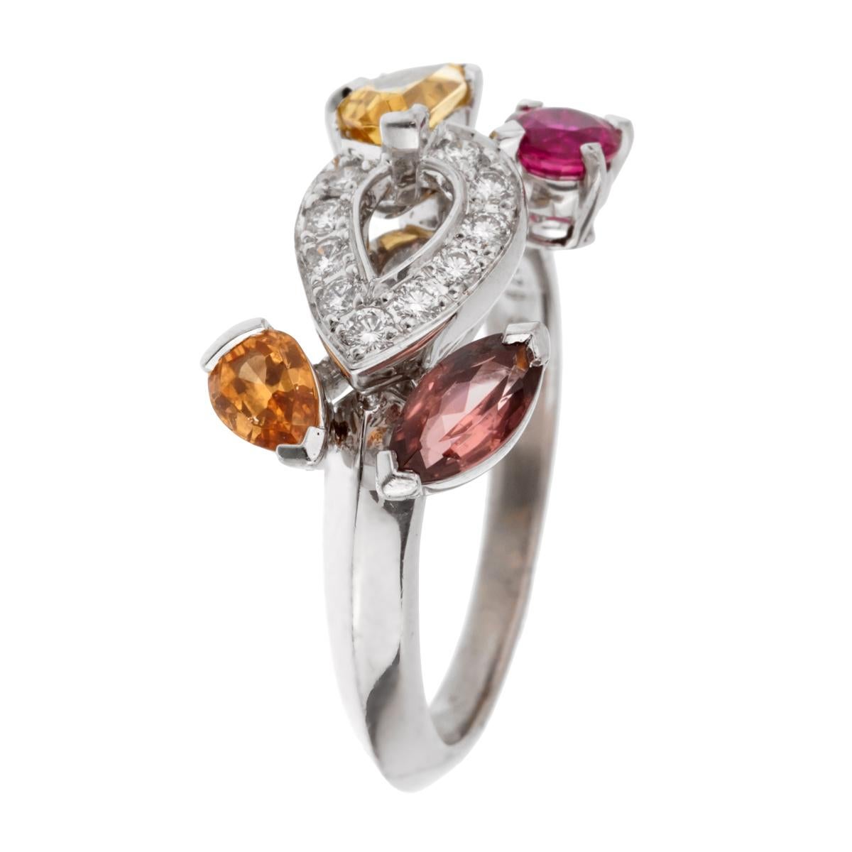 A fabulous Cartier crafted in 18k white gold adorned withwith diamond, ruby, tourmaline, citrine and imperial topaz stones. The ring showcases a knife edge design and measures a size 6 1/2 (Resizeable)