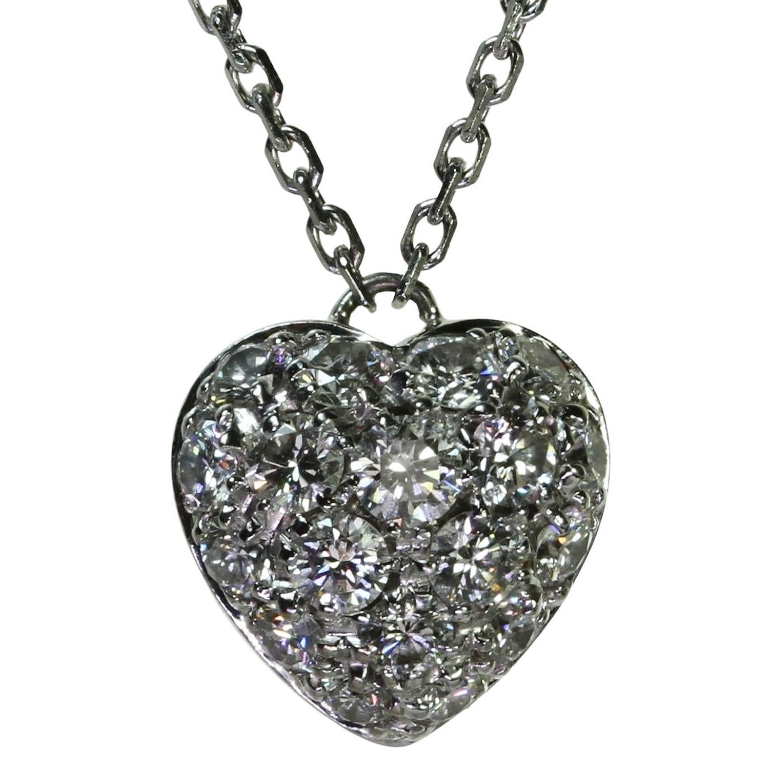 This gorgeous authentic Cartier necklace is crafted in 18k white gold and features a heart-shaped pendant pave-set with round brilliant D-E-F VVS1-VVS2 diamonds weighing an estimated 0.50 carats. Made in France circa 1990s. Measurements: 0.31
