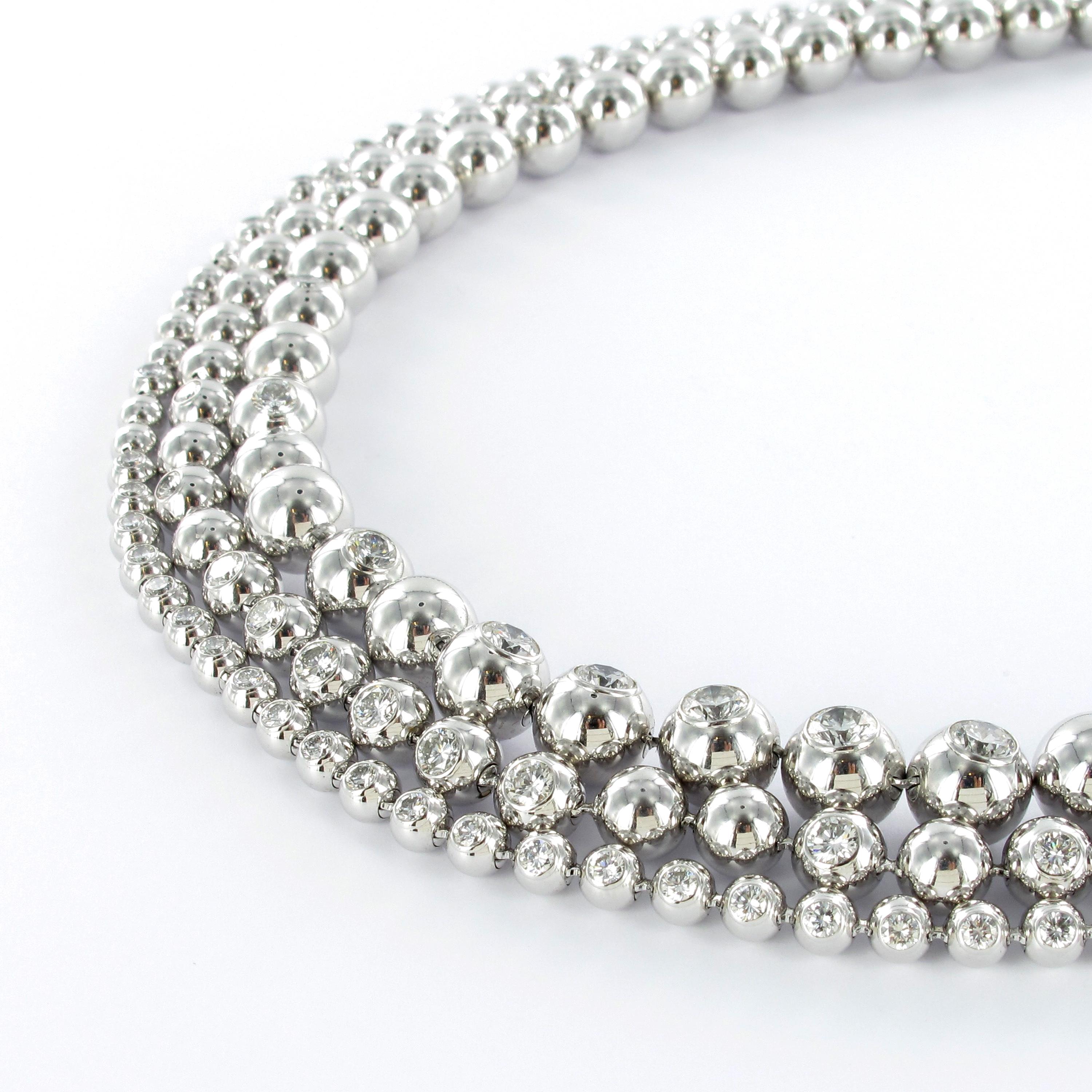 Impressive Cartier three-row diamond bracelet of the 'Perles de Diamants' collection. Polished beads are flush-set with 79 round brilliant-cut diamonds of 8.08 carats, F color and vs clarity.
Signed and numbered CRN7020801.

Maker's mark: