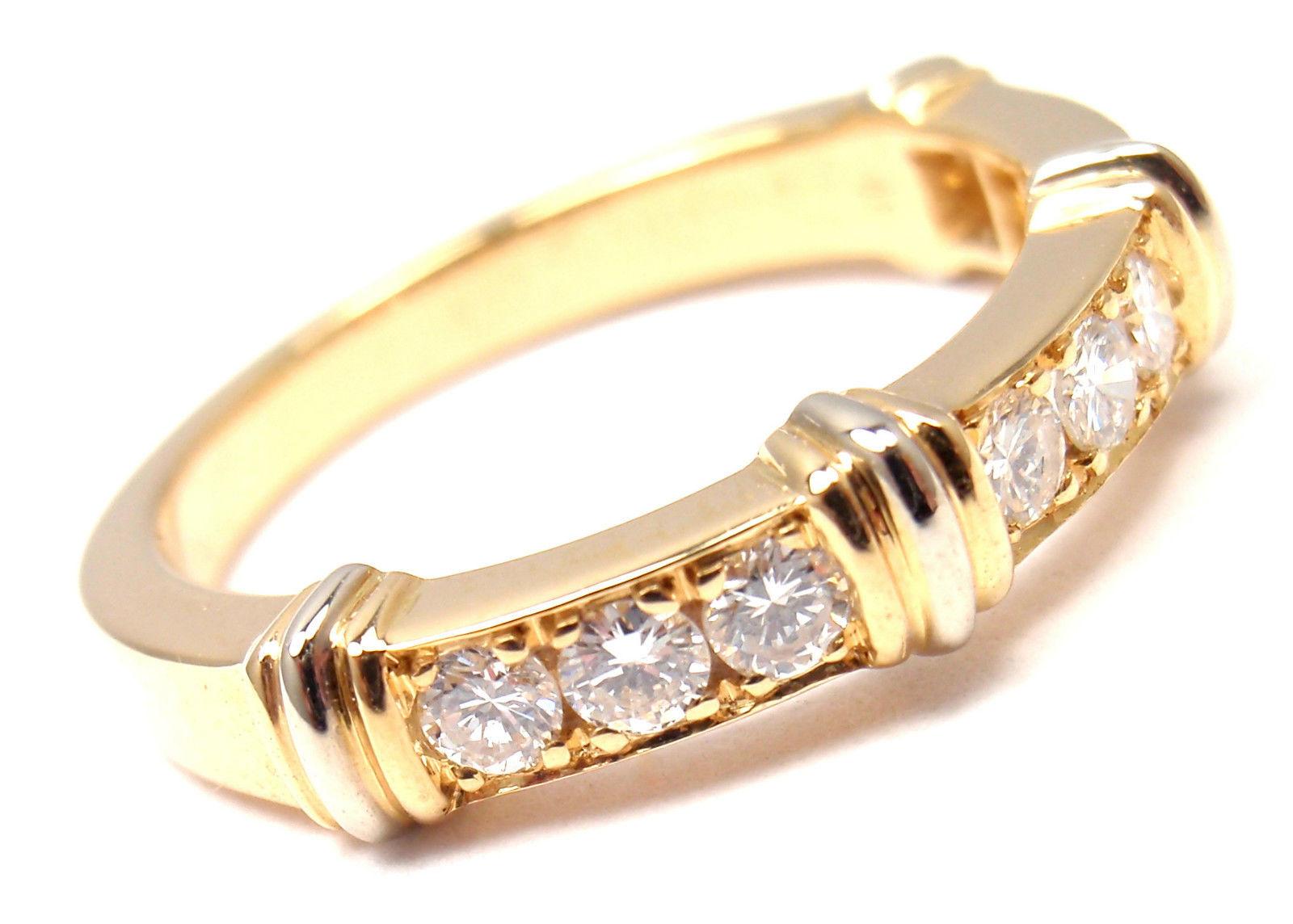18k Yellow Gold Diamond Band Ring by Cartier. 
With 9 round brilliant cut diamonds VVS1 clarity, E color total weight approximately  .18ct 
Details:
Ring Size:  US 4 1/2, European 48
Width: 2.5mm
Weight: 3.9 grams
Stamped Hallmarks: Cartier 750  48