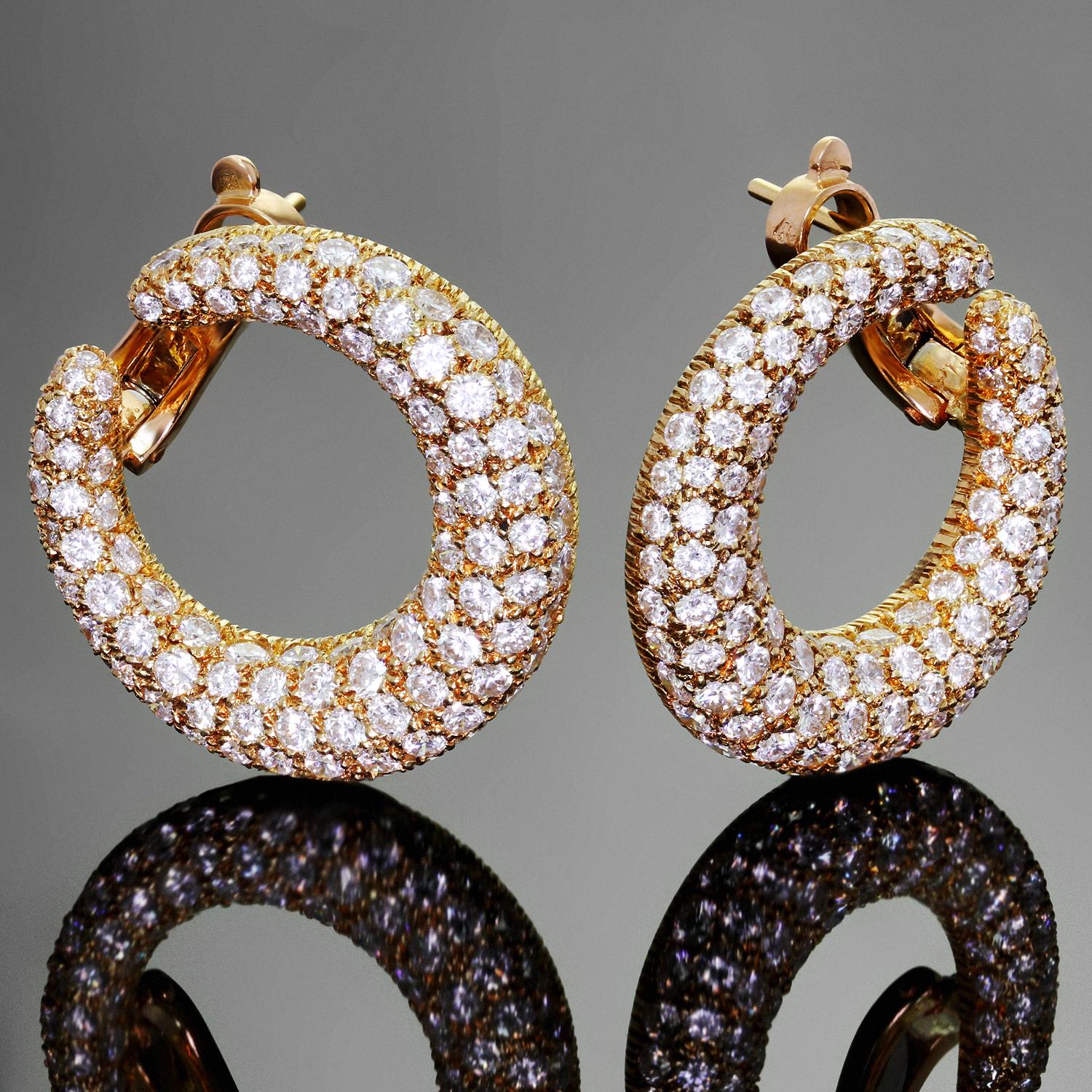 These iconic Cartier earrings feature a sparkling hoop design crafted in 18k yellow gold and set with briliant-cut round D-E VVS1-VVS2 diamonds of an estimated 6.50 carats. Completed with lever backs and posts for pierced ears. Made in France circa