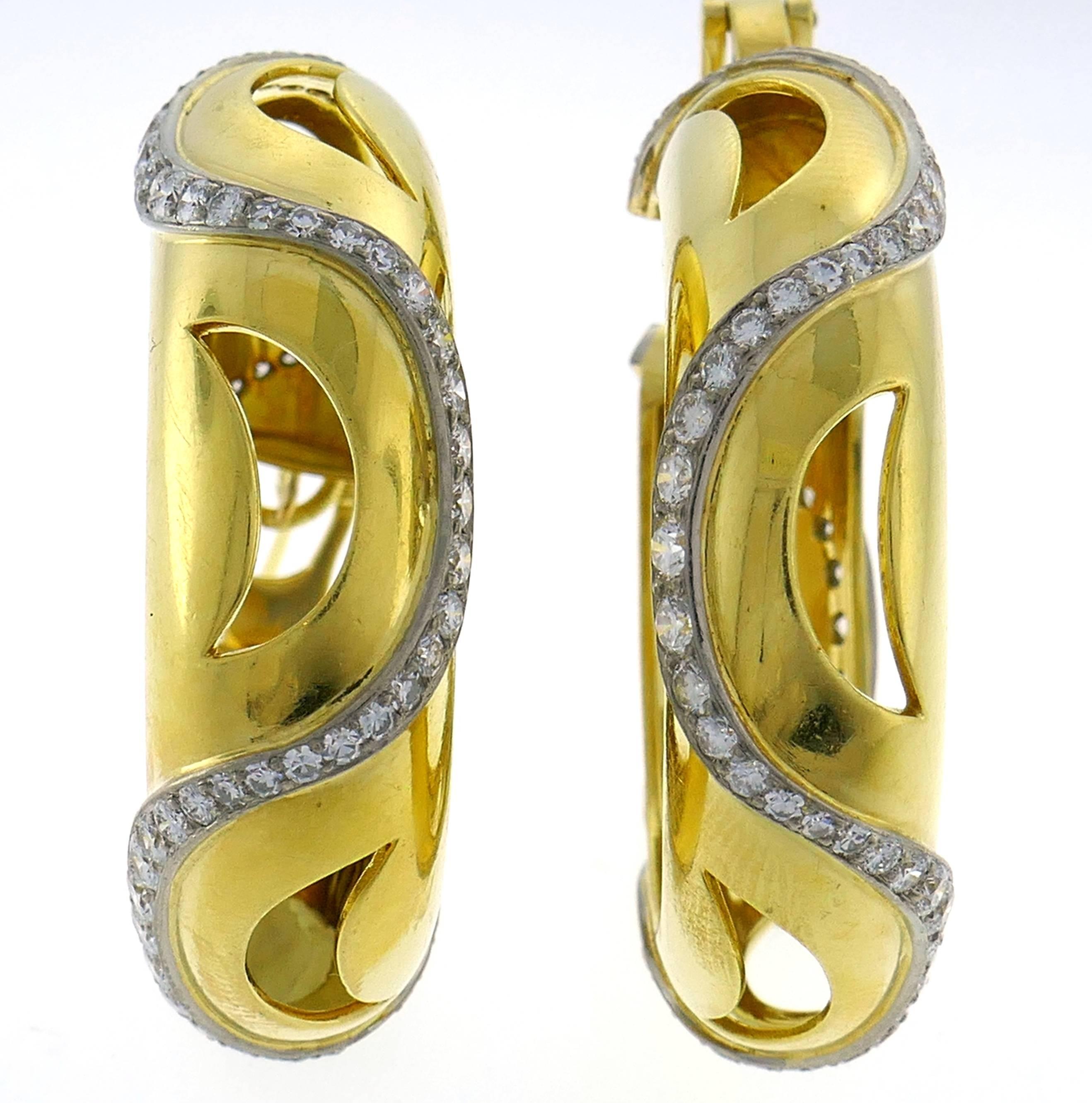 Chic and wearable stylized hoop earrings that are a great addition to your jewelry collection. 
Created by Cartier in London. 
Made of 18 karat (tested) yellow gold and set with round brilliant cut diamonds (F-G color, VS1 clarity, total weight