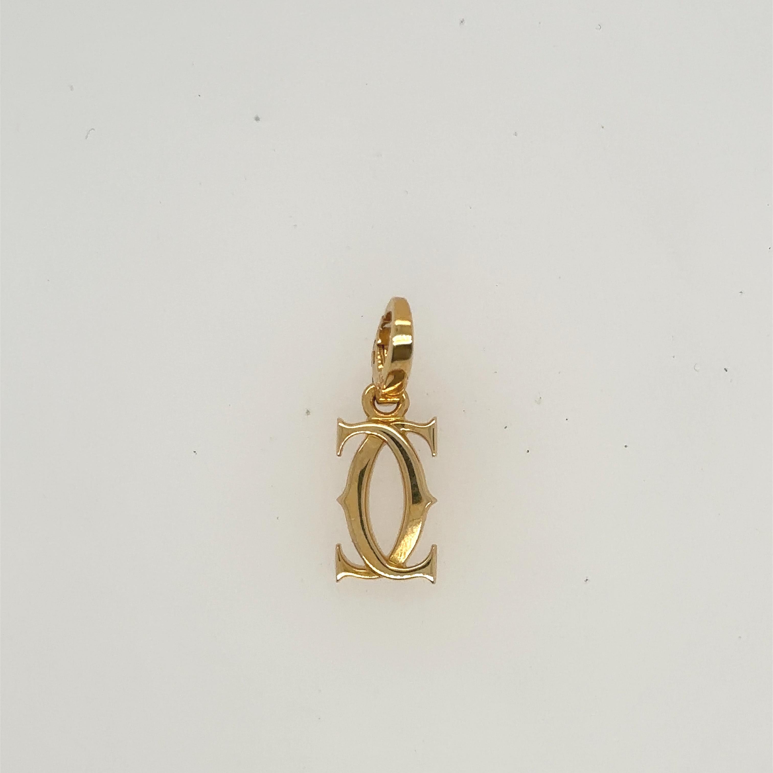 Cartier double C charm/pendant.
18k yellow gold.
Comes with box and certificate.
Total weight: 2.5 grams
3 cm tall.
Stamped 18k, cartier