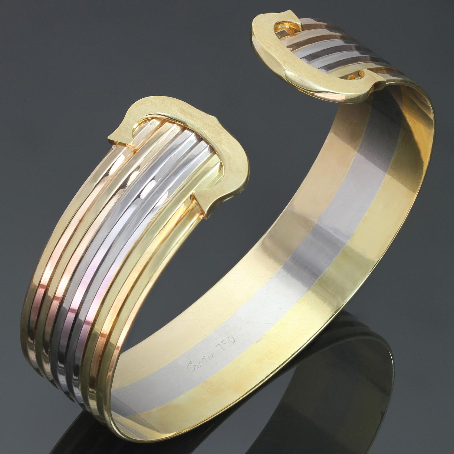 This classic Cartier bangle bracelet features a three-row design crafted in 18k yellow, white and rose gold and completed with the iconic Double C logos in yellow gold. The hallmarks are faint but visibel. Made in France circa 1997. Measurements: