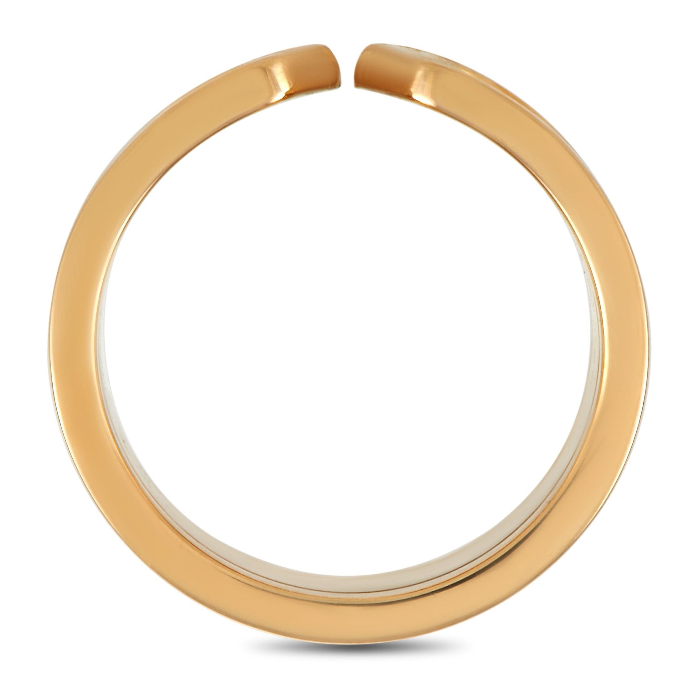 With a simple, sleek, and suave design, this Cartier Double C 18K Yellow Gold Wide Band Ring will lend a stylish edge to any ensemble. The ring features a 10mm wide band crafted in 18K yellow gold. It has an open shank design, a polished bordered