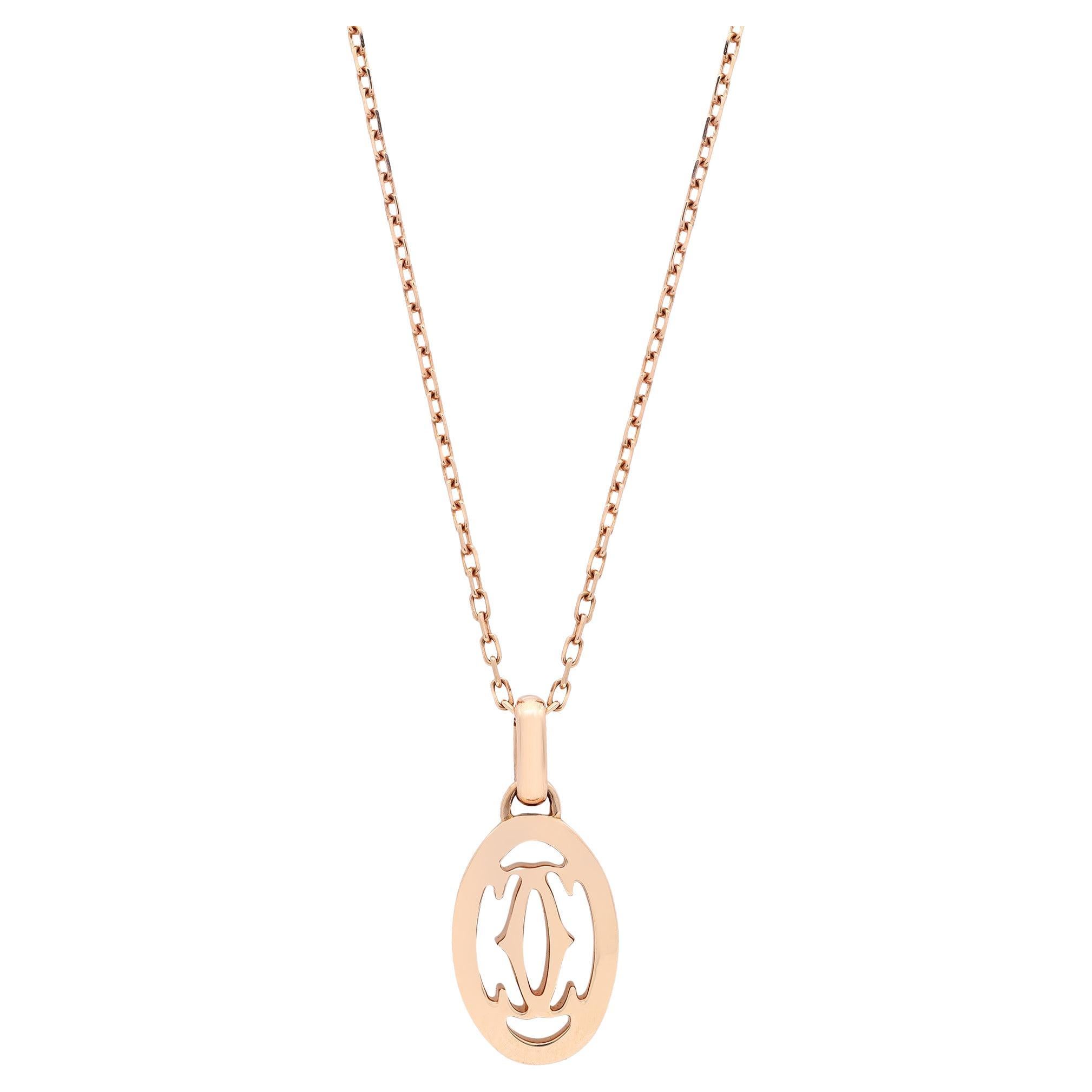 This stunning Double C de Cartier diamond logo pendant necklace is crafted in fine 18k rose gold. It features 37 pave set round brilliant cut diamonds weighing 0.10 carat in total. Chain length: 16.5 inches. Total weight: 4.40 grams. Excellent