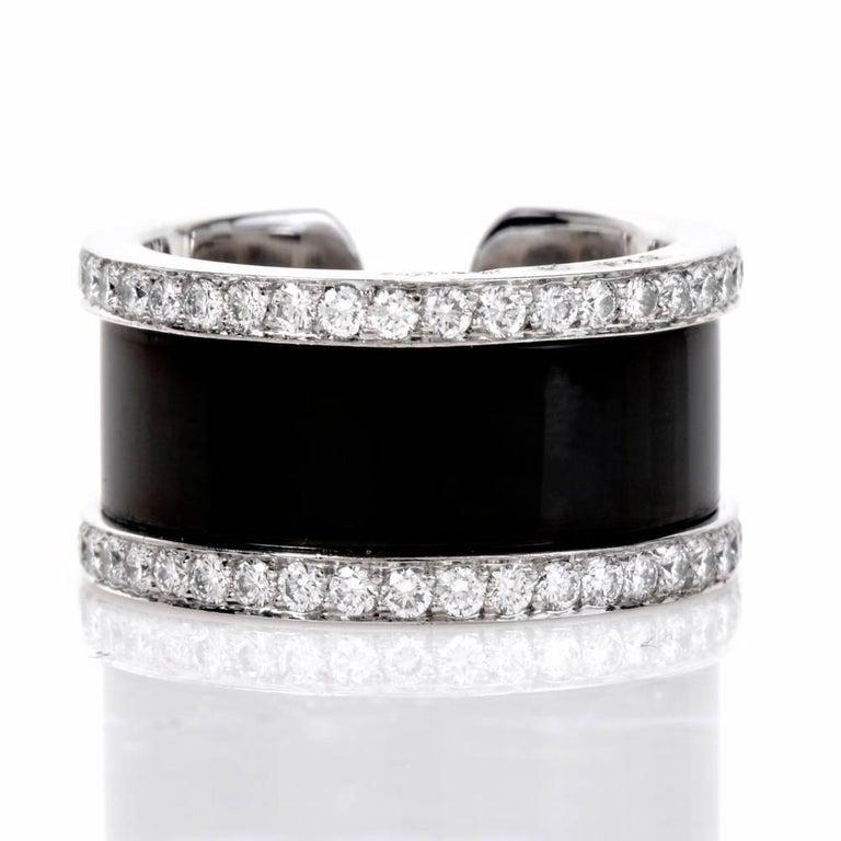 This Cartier Diamond open band “Double C”, displays a double C open design with its band embellished with a black finish.

Crafted in solid 18K white gold, is enclosed within a frame of 76 genuine round cut Diamonds approx: 1.60 carats, E-F color,