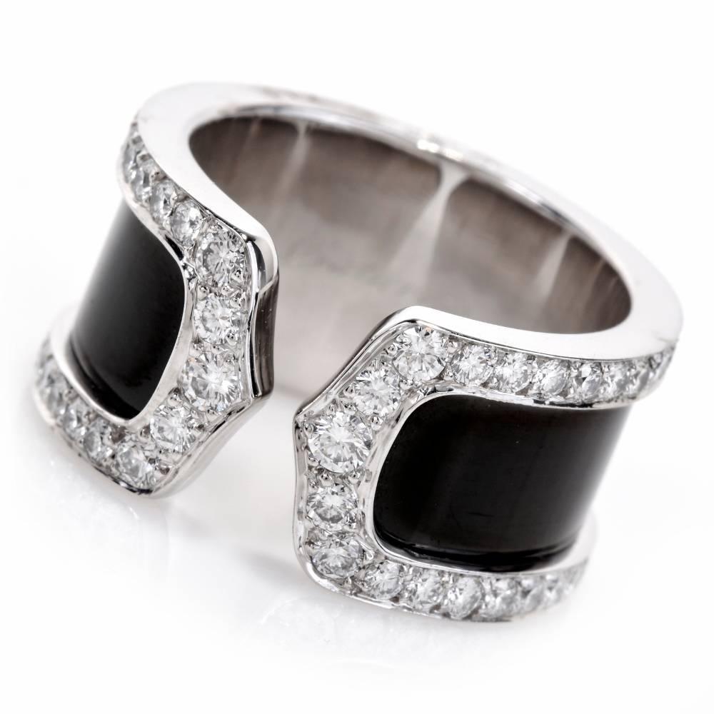 This dazzling Cartier Diamond  open band “Double C” crafted in solid 18K white gold.It displays a double C open design with its band embellished with black finish enclosed within a frame of 76 genuine round cut Diamonds approx: 0.90cttw, E-F color,