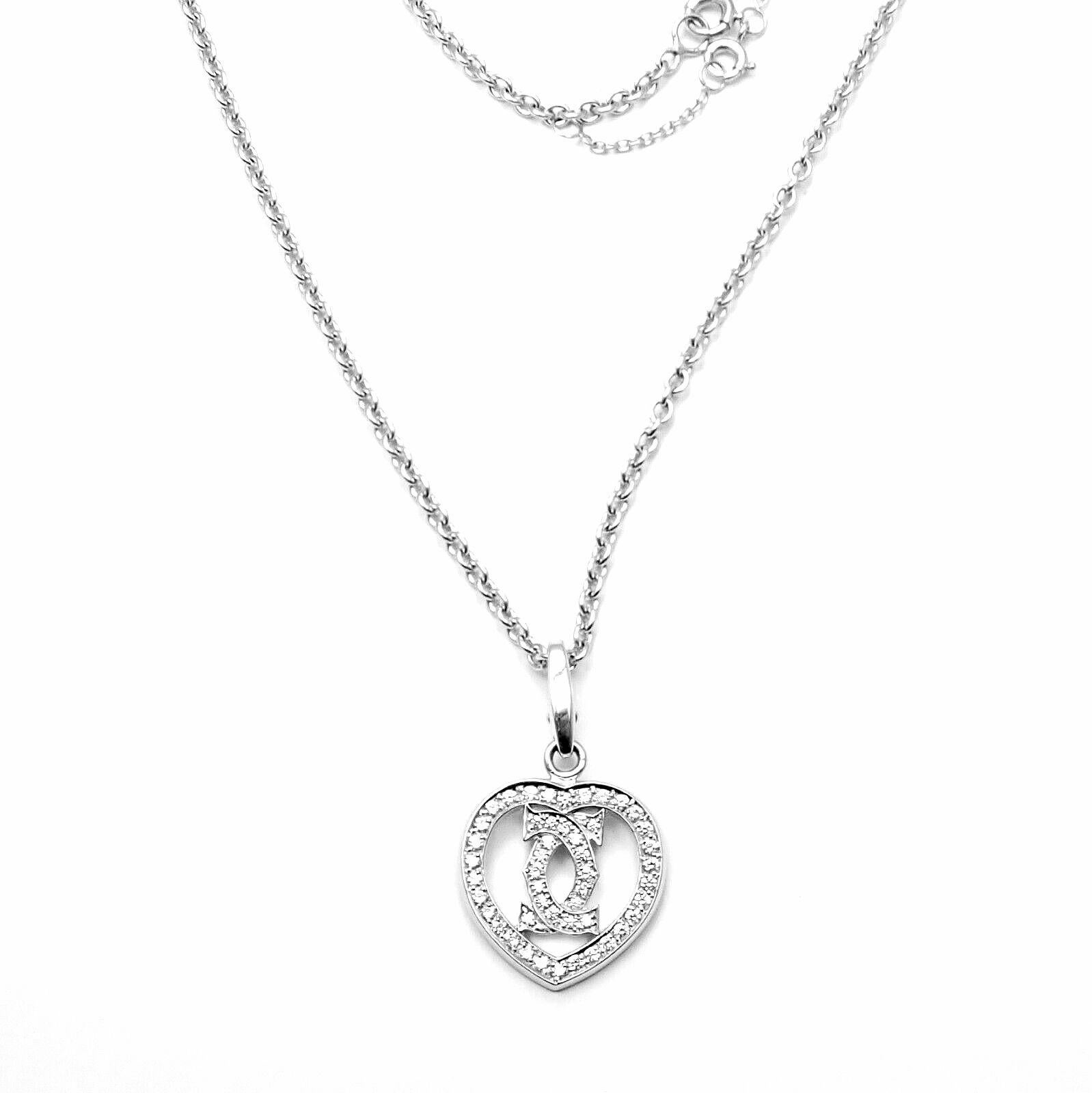 18k White Gold Diamond Heart Double C Pendant Necklace by Cartier.
With 49 round brilliant cut diamonds
VVS1 clarity, E color total weight approx. .50ct
This necklace is in mint condition and comes with original Cartier box.
Details:
Chain Length: