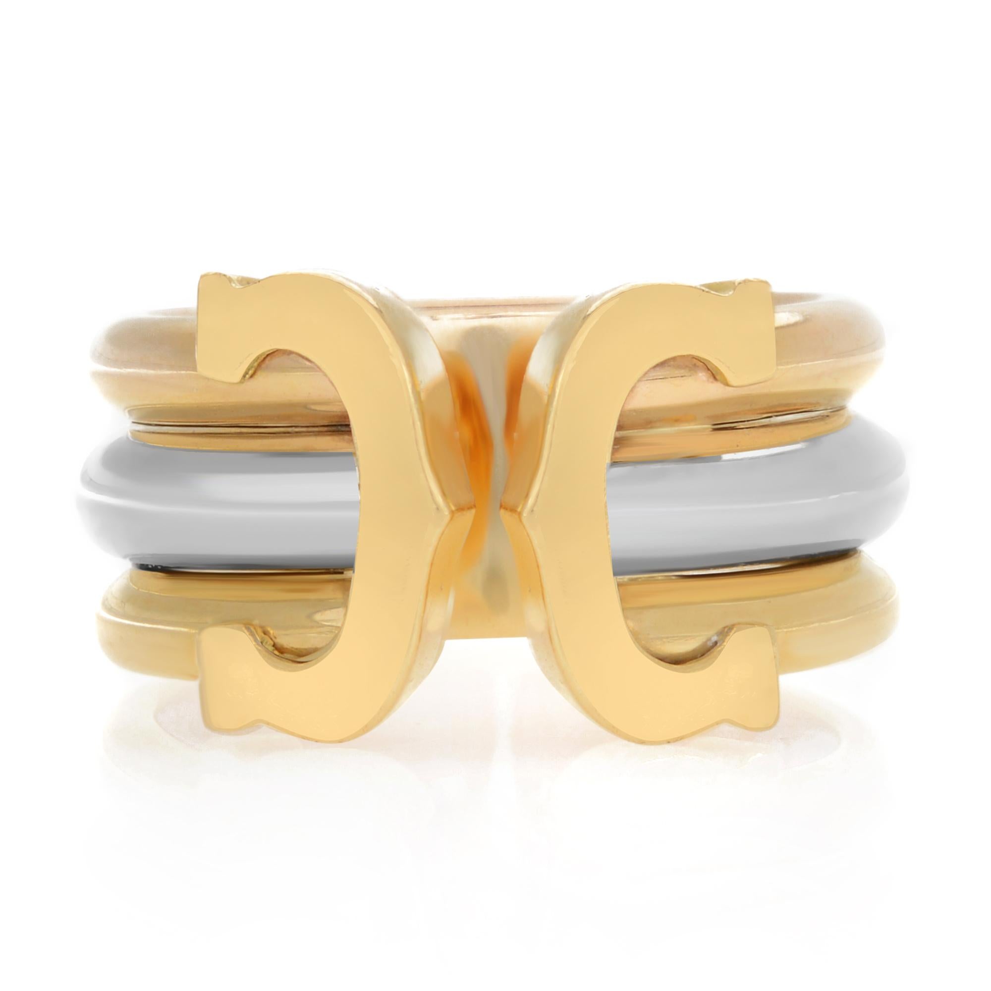 Cartier ring from the Double C Collection, crafted in solid 18k yellow, rose and white gold with a high polished finish. The band has 3 thick wire rings joined and stacked together forming a gorgeous 9mm wide band. It is fully signed by the designer