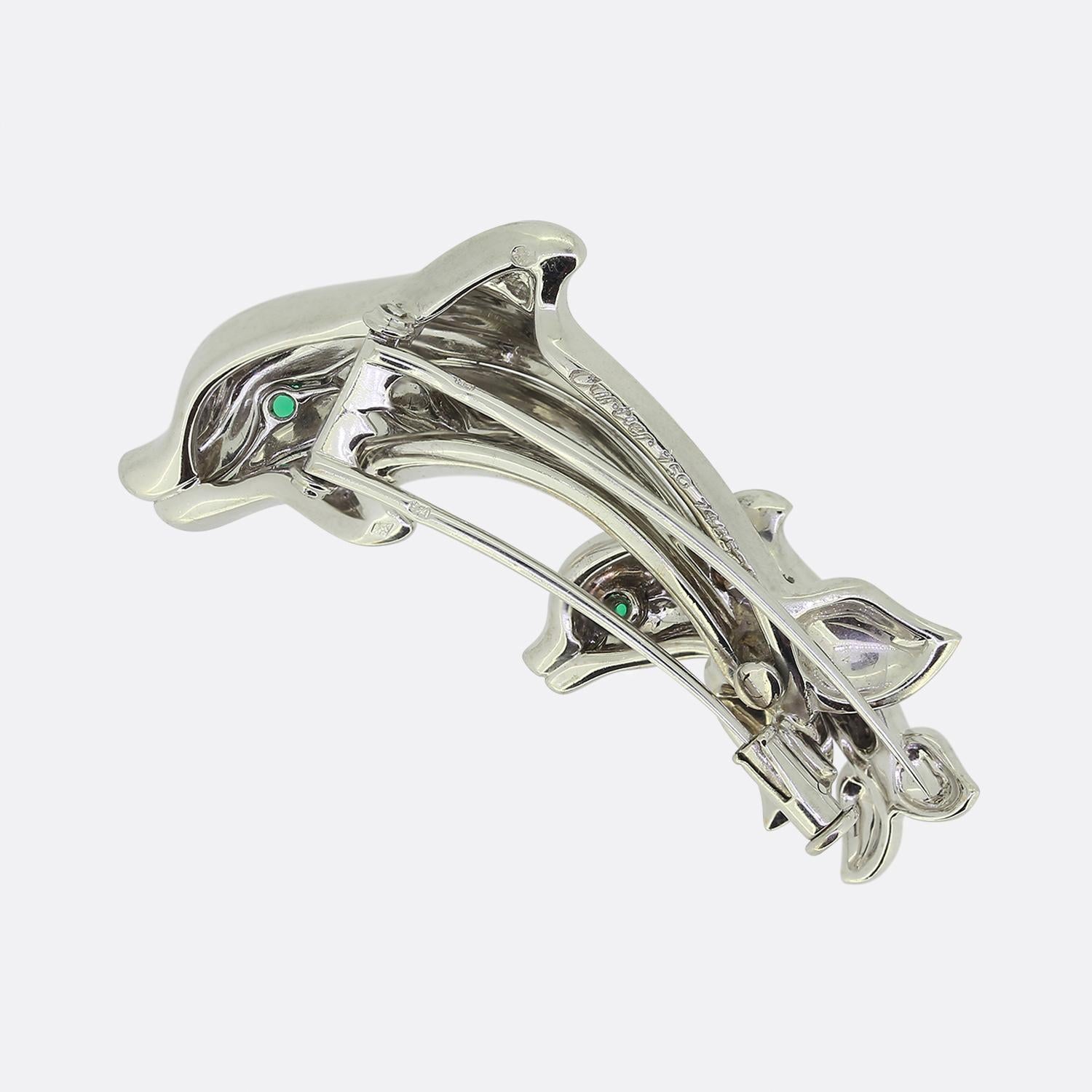 Here we have a quirky brooch from the world renowned luxury jewellery house of Cartier. This piece has been crafted from 18ct white gold into the shape of a pair of porpoising dolphins. This piece is highly detailed with duo of round faceted