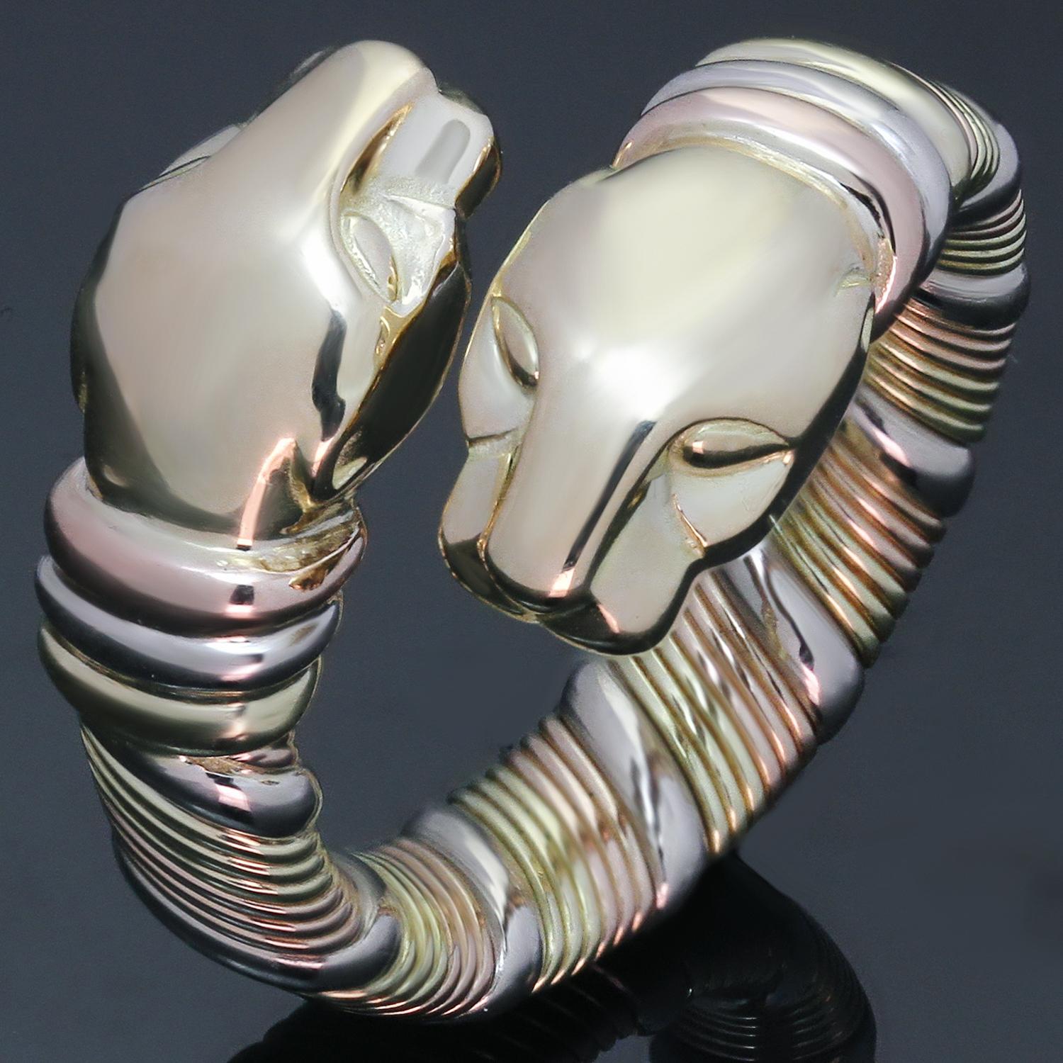 This fabulous Cartier ring features a coiled double headed panther design crafted in 18k yellow, white, and rose gold. The ring is slightly flexible from size 6 to 6.5. Made in France circa 1980s. Measurements: 0.59
