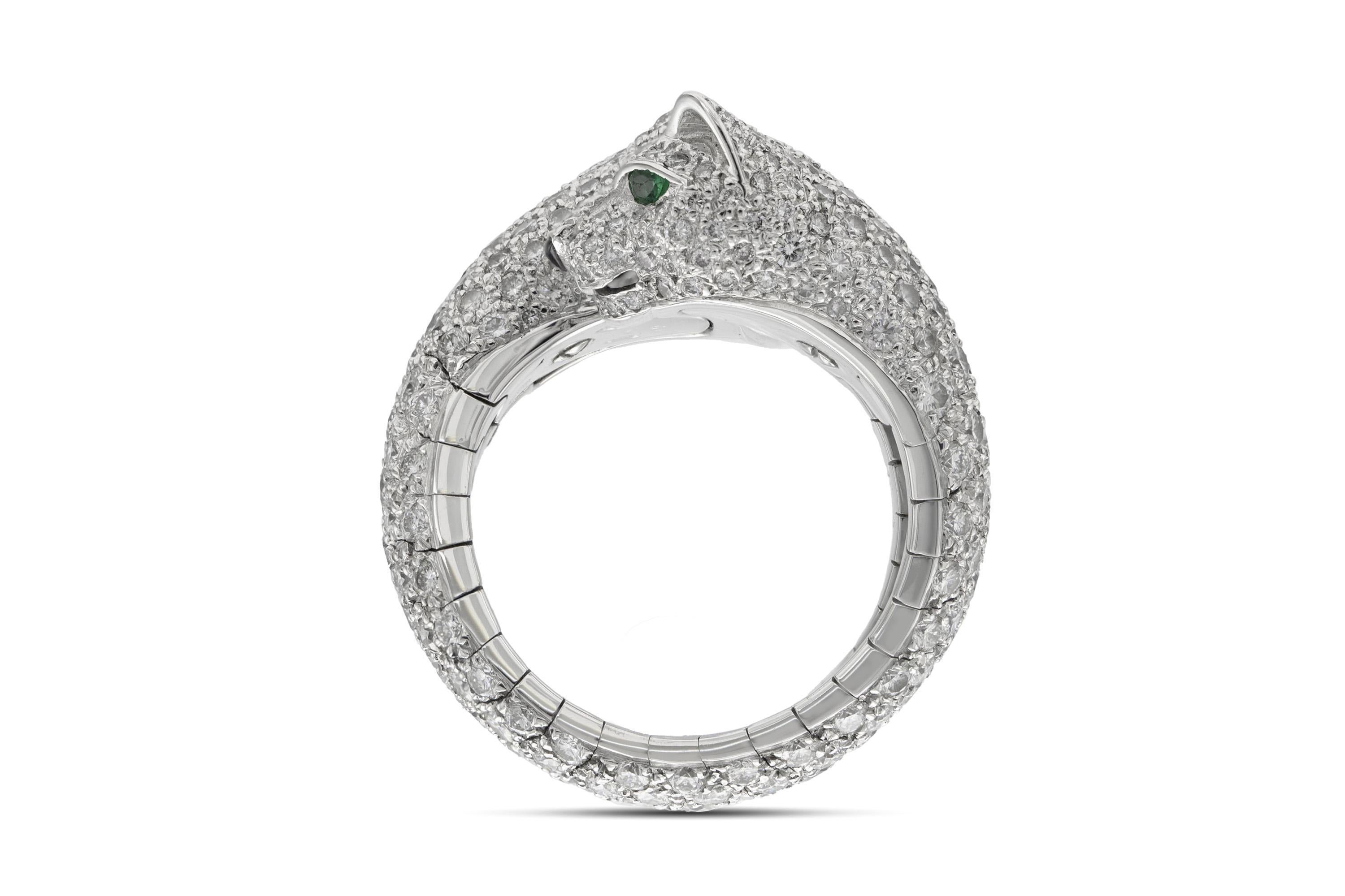 Finely crafted in 18k white gold with pave set Round Brilliant cut Diamonds weighing a total of approximately 6.50 carats, Emeralds, and Onyx.
Signed by Cartier, from their Pathere Collection
Flexible, size 8 - 8 1/2
Comes with its original box.