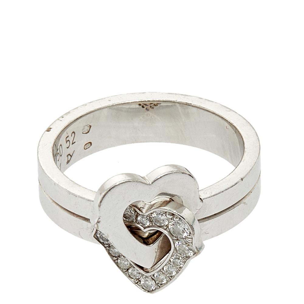 We are 'heart eyes' over this Cartier cocktail ring. Sculpted using 18k white gold, the luxurious jewel has a dual-band style centered with two hearts interlocked with one another. Diamonds on one of the hearts give the creation a stunning