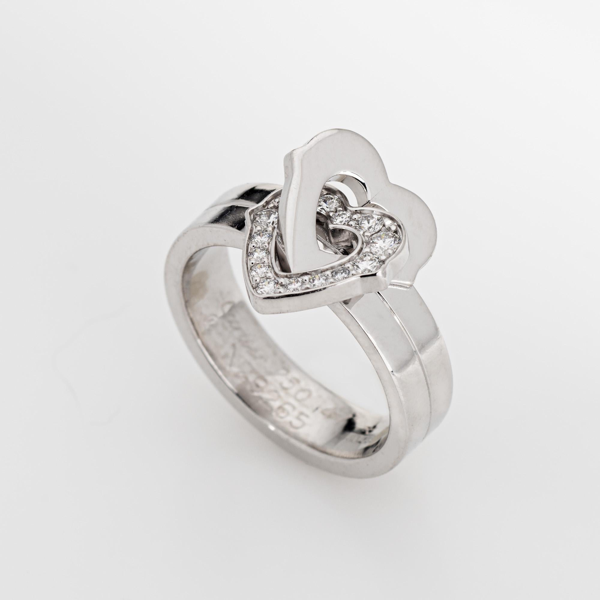 Pre-owned Cartier double heart diamond ring crafted in 18k white gold (circa early 2000s).  

Diamonds total an estimated 0.15 carats (estimated at G-H color and VS1-2 clarity). 

The sweet double heart design is set with diamonds to one of the