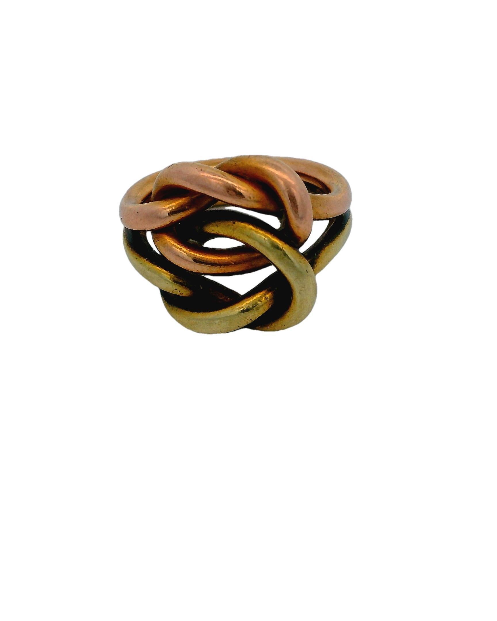 C. 1970

This unique ring is crafted in 14K gold. It features an intricate interlocking design with smooth, rounded bands in a warm, polished finish.

The ring is a creation by Cartier.

Ring size 3.75, resizable. 

Total weight is 10.8 g.