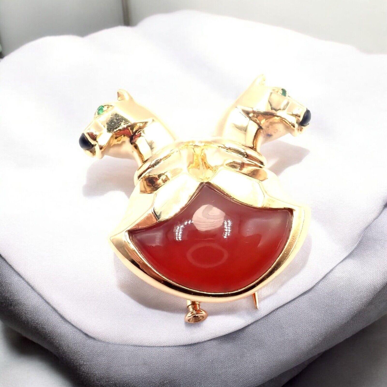 18k Yellow Gold Emerald Jasper Black Onyx nose Double Panther Panthere Pin Brooch by Cartier. 
The Cartier Double Panther pin brooch is a captivating piece crafted in 18k yellow gold, featuring two majestic panthers. 
Their eyes are set with onyx,