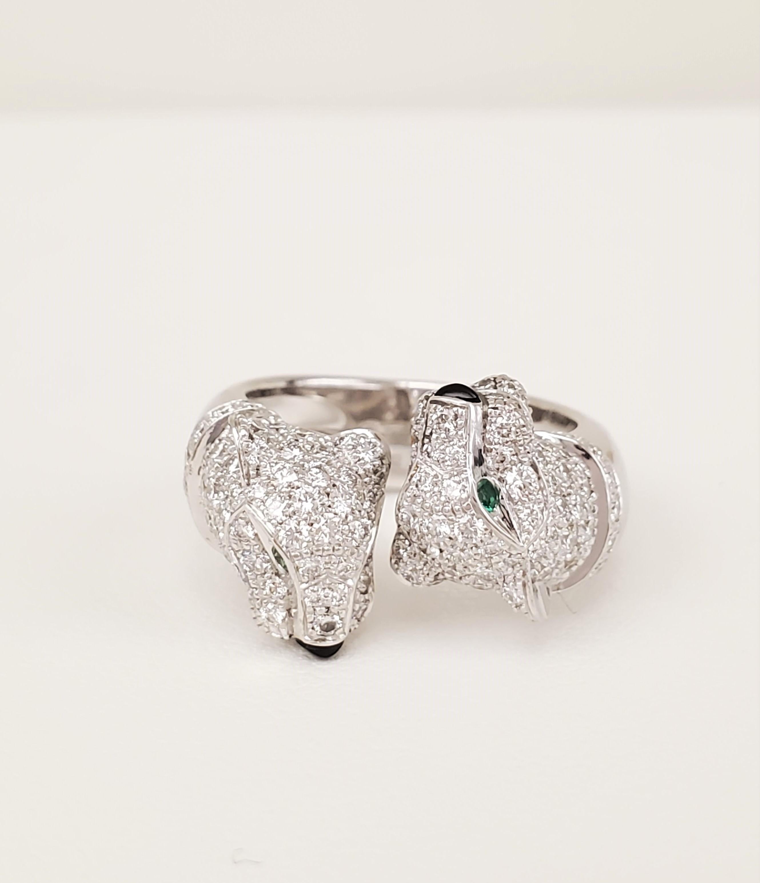 Authentic rare Cartier ring from the Panthere collection centering on two opposing panther heads. The ring is crafted in 18 karat white gold and set with approximately 1.25 carats of round brilliant cut diamonds (E-F color, VS clarity). The panther