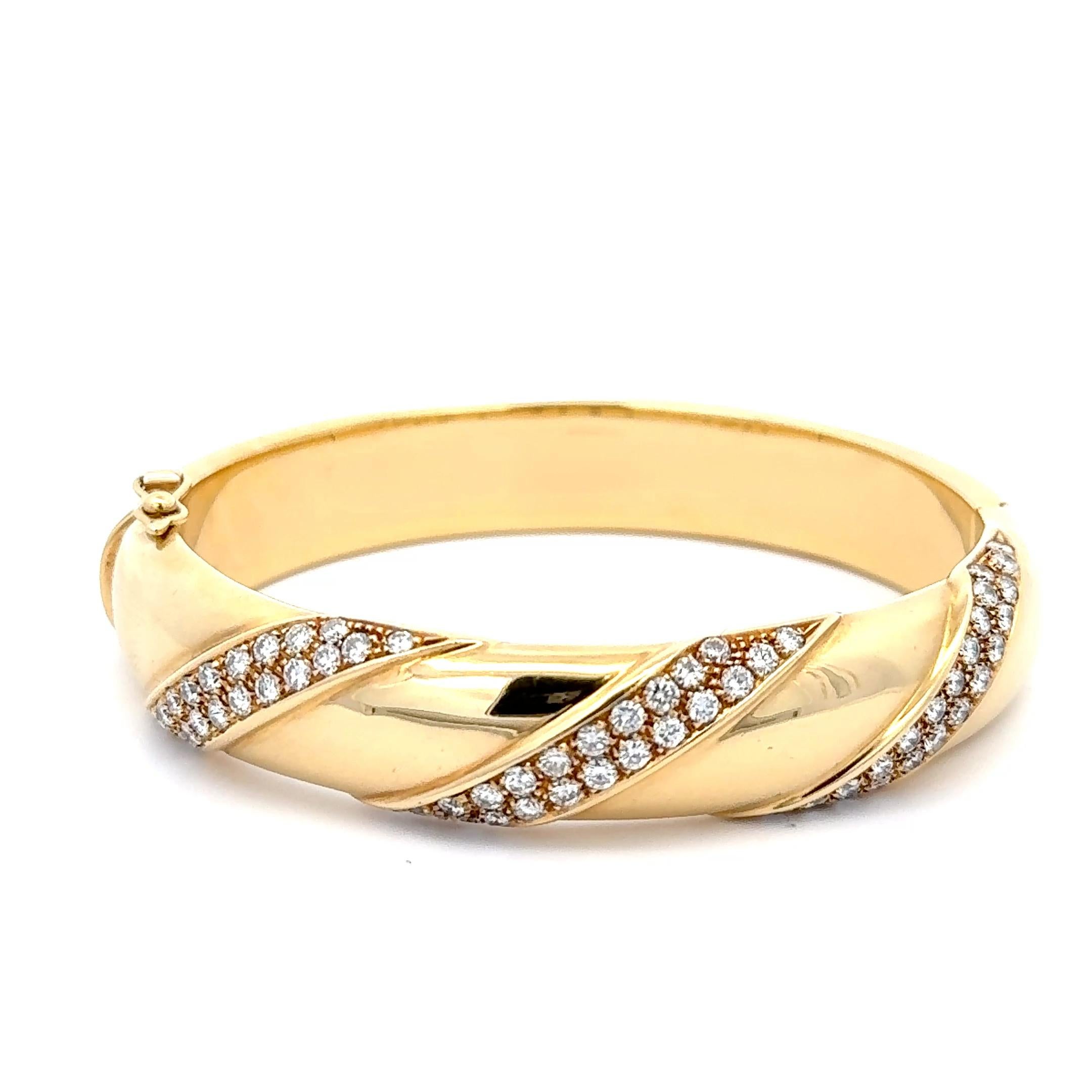 Cartier Double Ribbon Diamond Bracelet in 18K Yellow Gold. The bracelet features approximately 2.10ctw of brilliant round diamonds. The bracelet has an inner diameter of 2.25