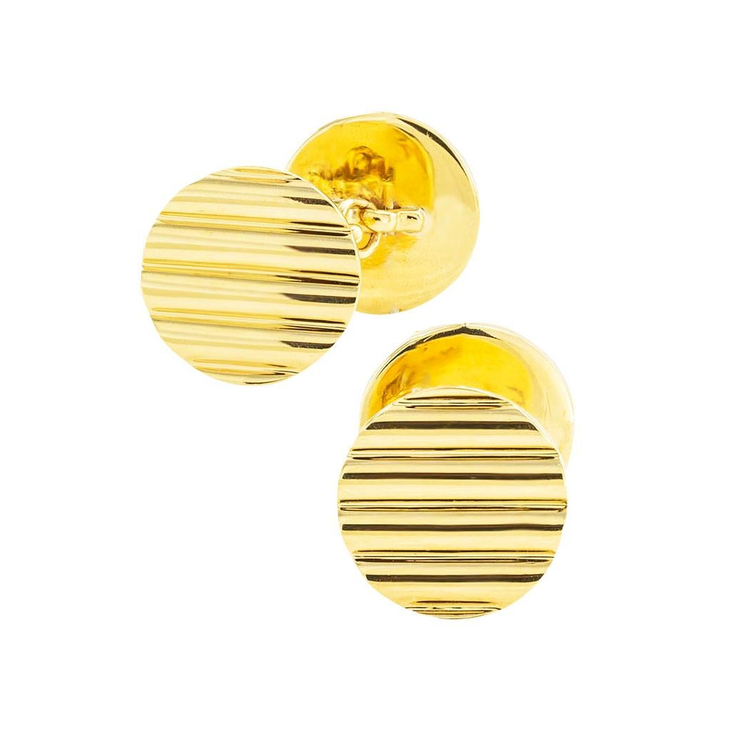 Cartier round yellow gold cufflinks circa 1960. *

ABOUT THIS ITEM:  #C-DJ104B. Scroll down for specifications.  The double-sided circular designs feature a ribbed pattern on both sides finished on bright polished gold.  These Cartier cufflinks are